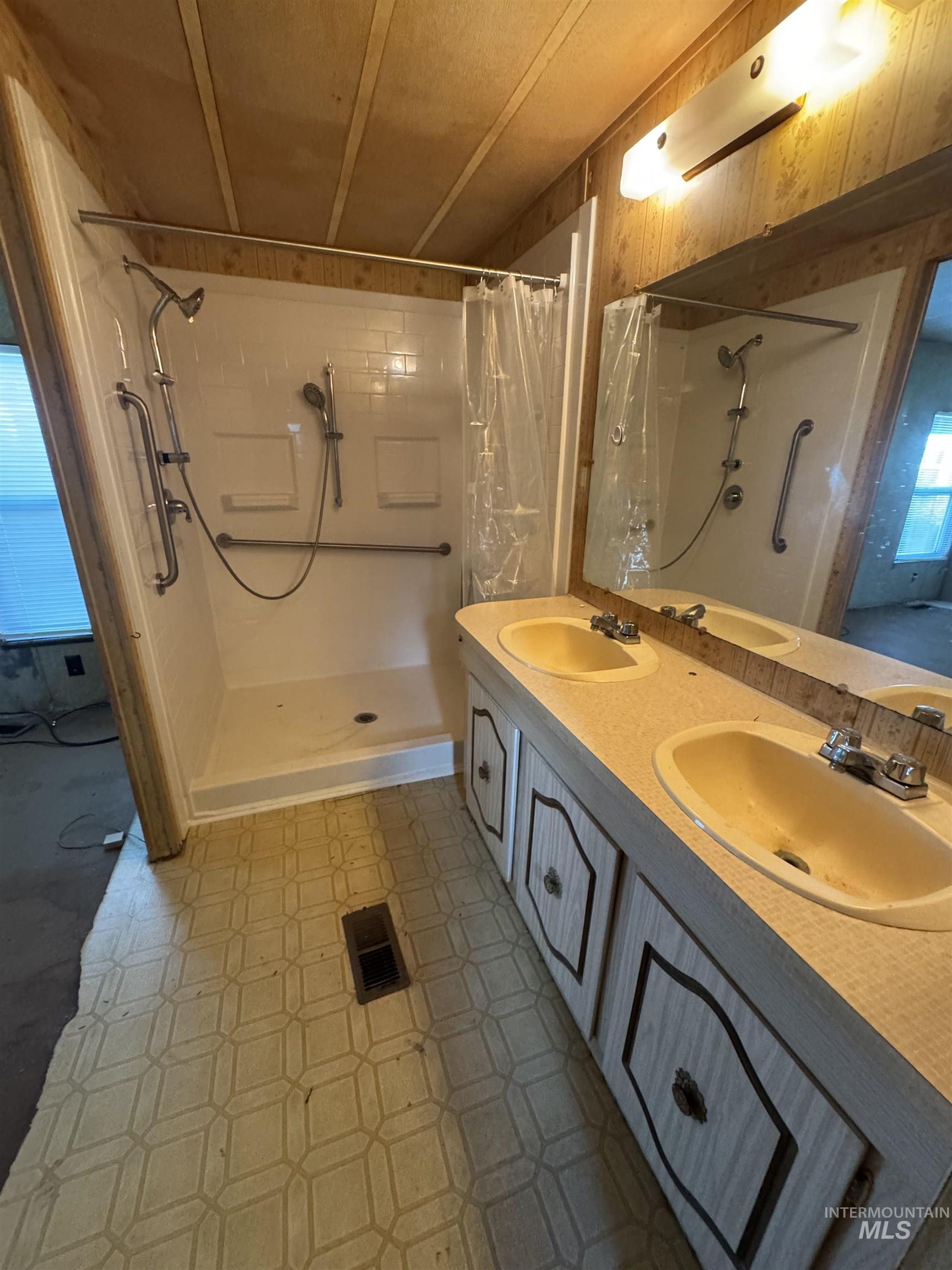 Bathroom with a shower stall and double vanity