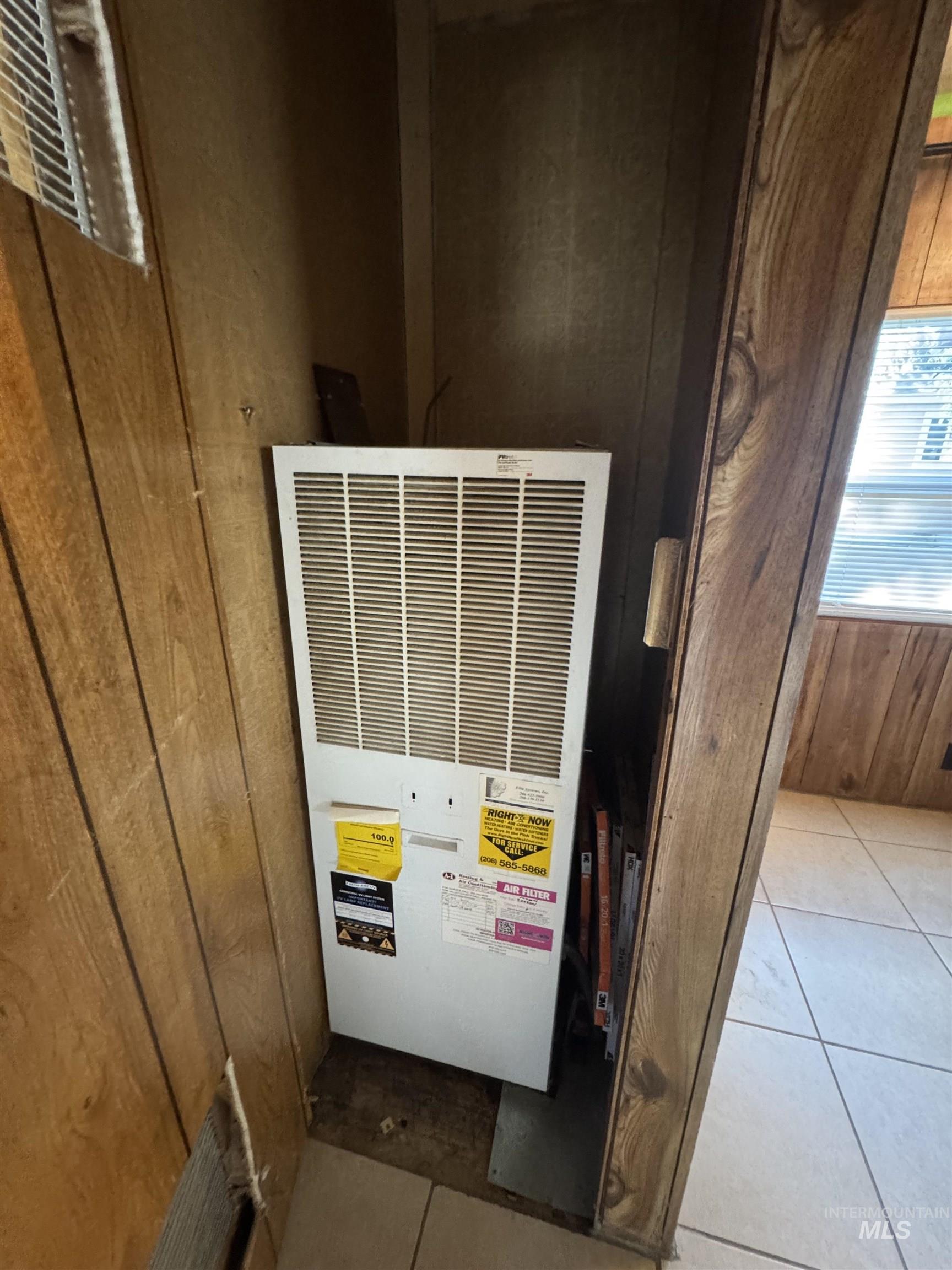 Detailed view of a heating unit and wood walls