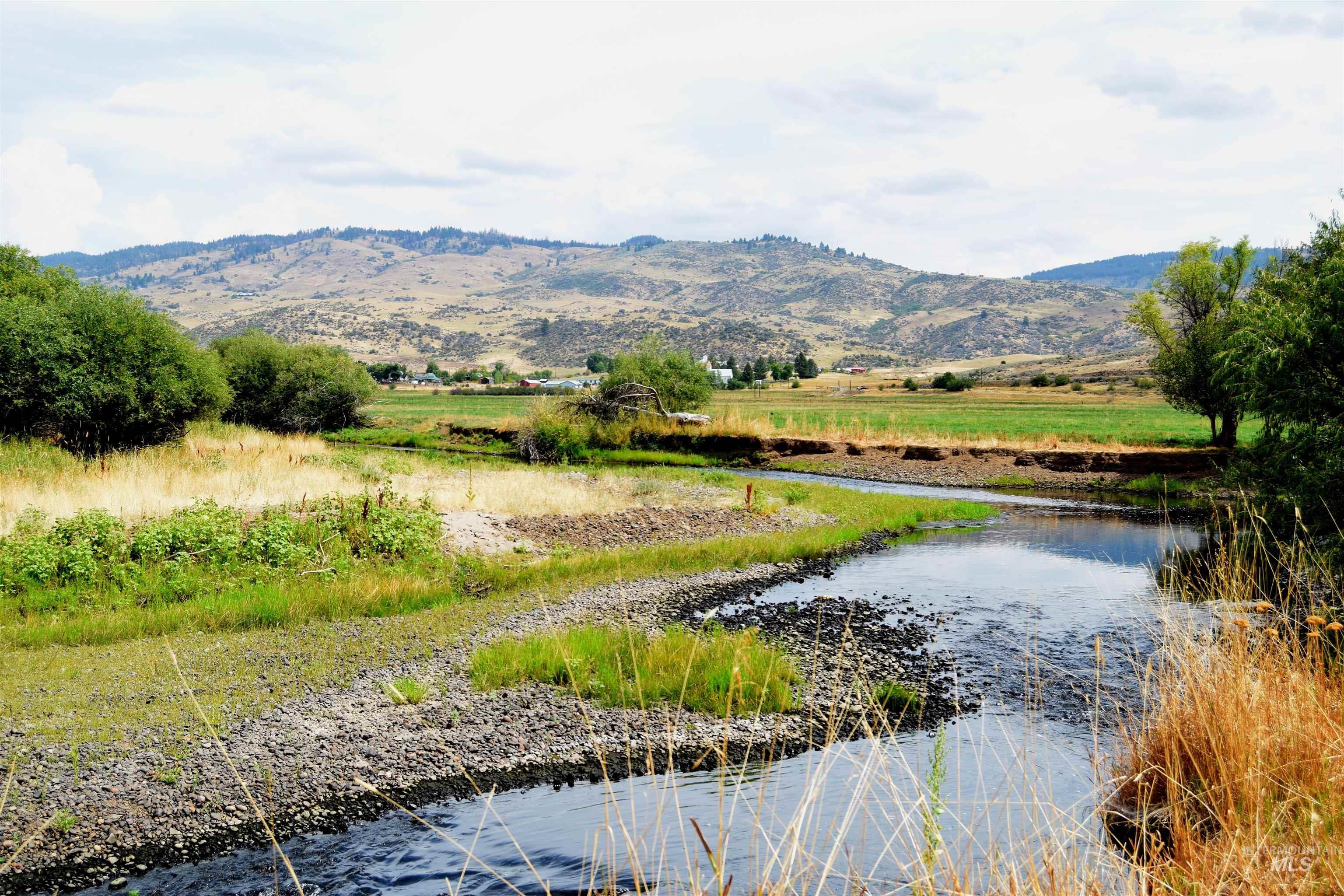 Water view with a mountainous background and rural landscape