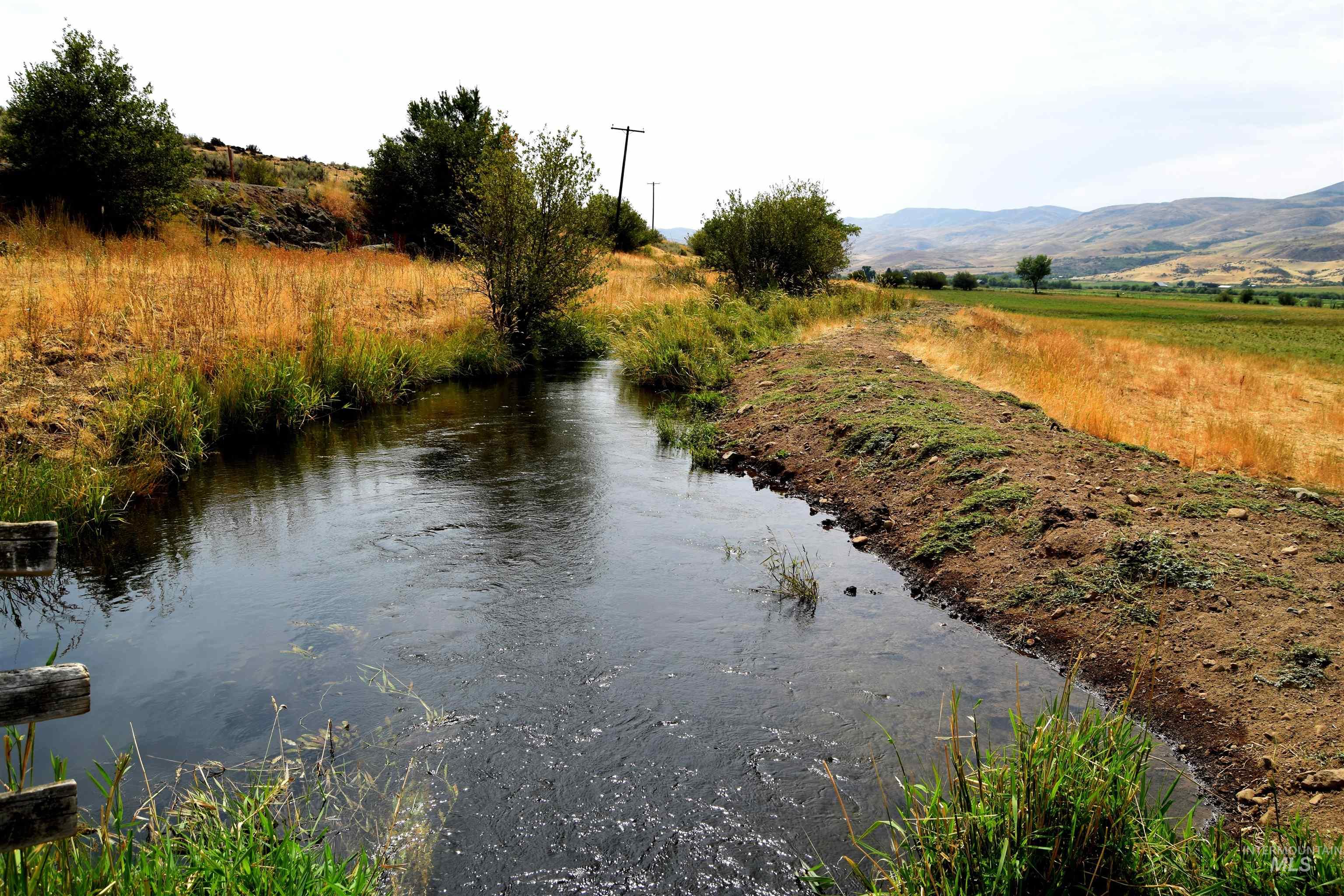 Water view featuring a mountainous background and rural landscape