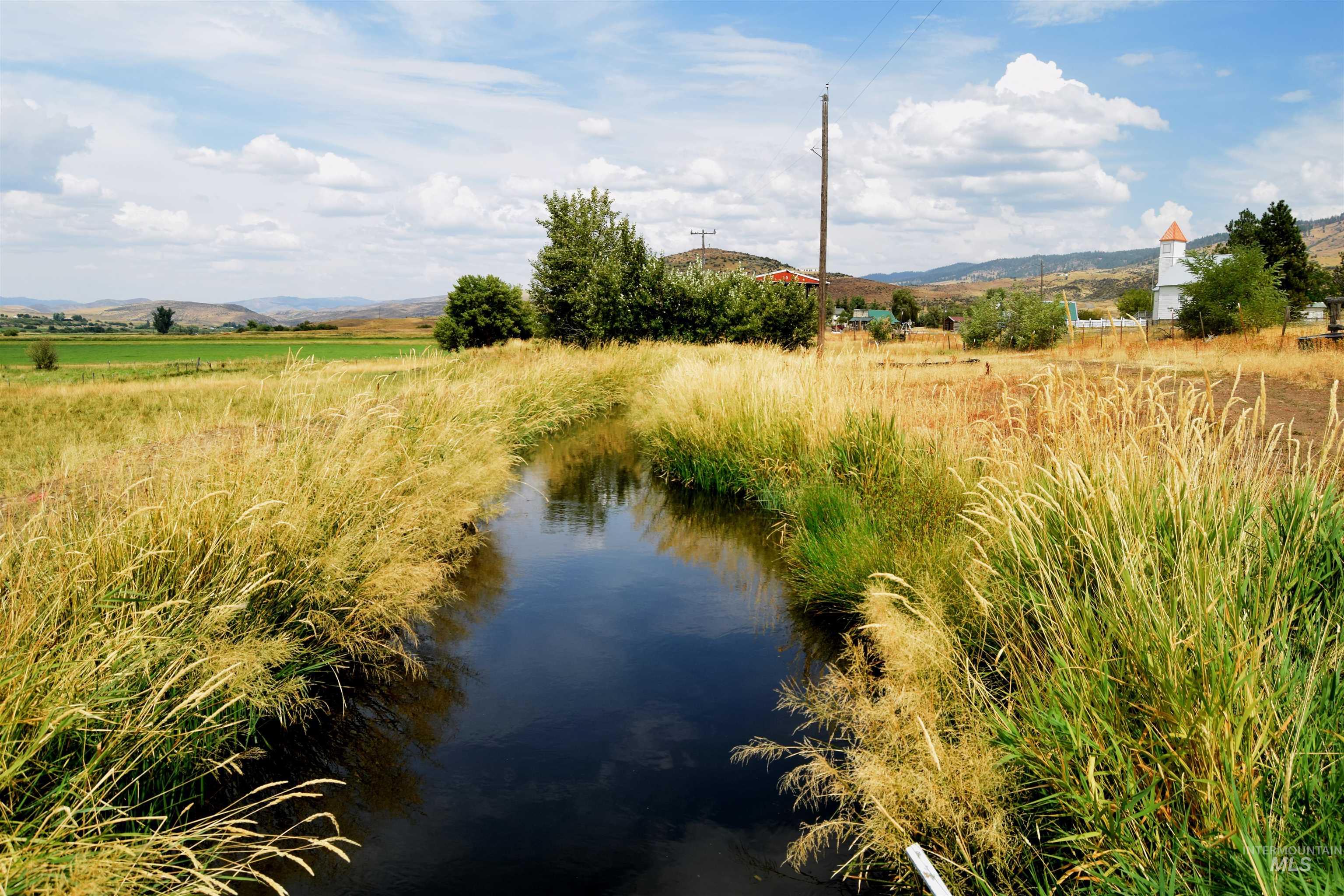 Water view featuring a mountainous background and rural landscape