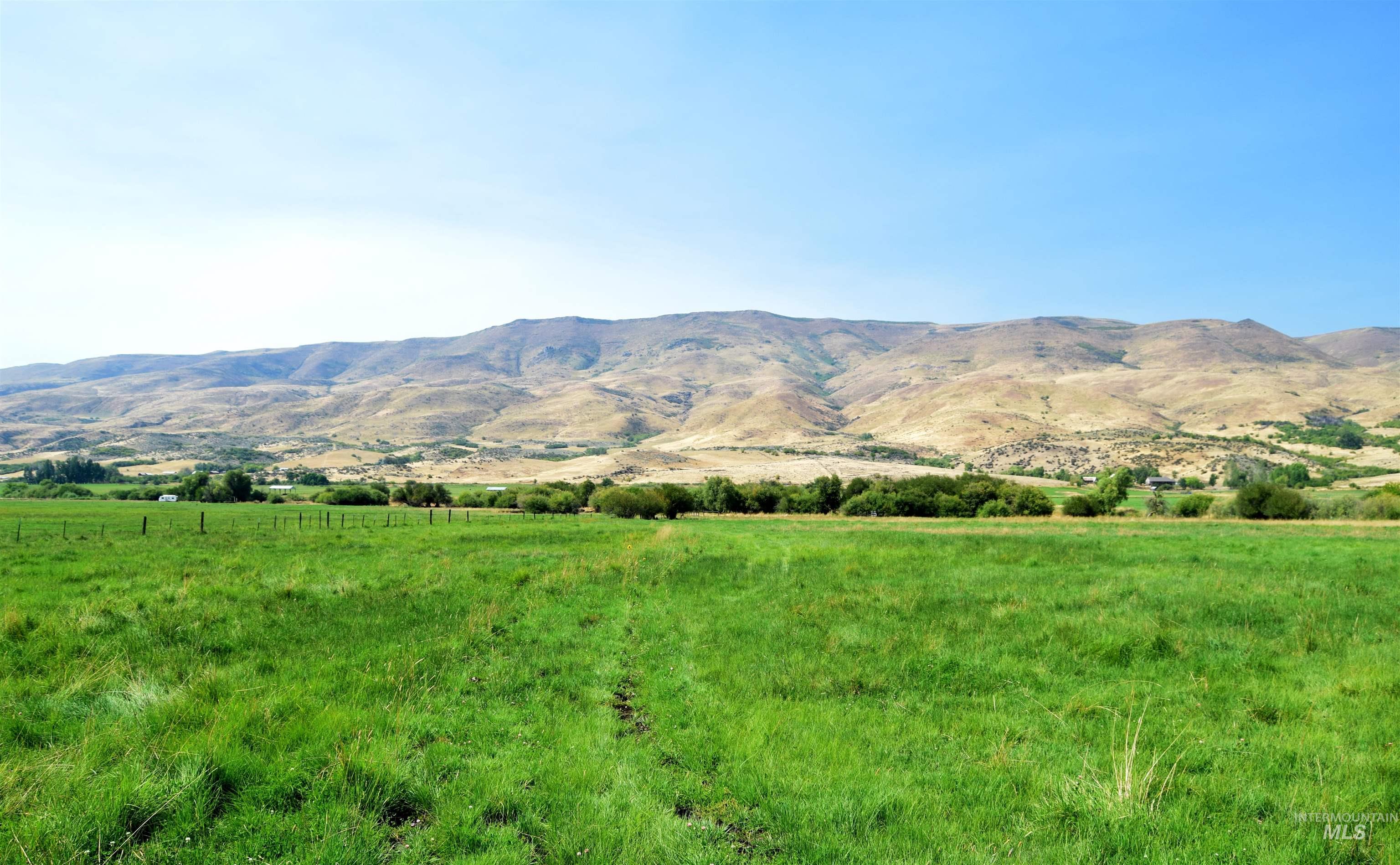 View of mountain backdrop with rural landscape