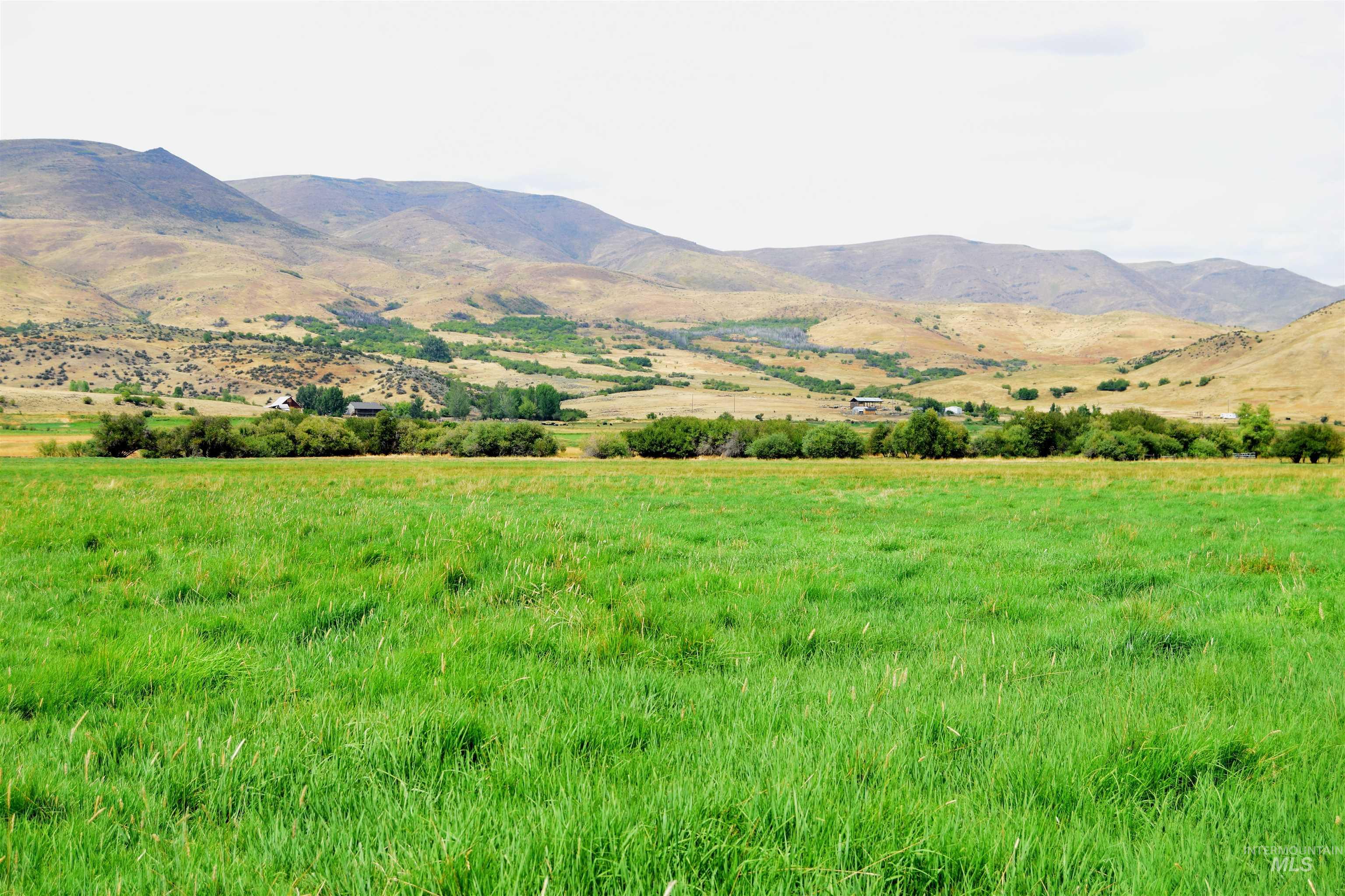 View of mountain backdrop with rural landscape