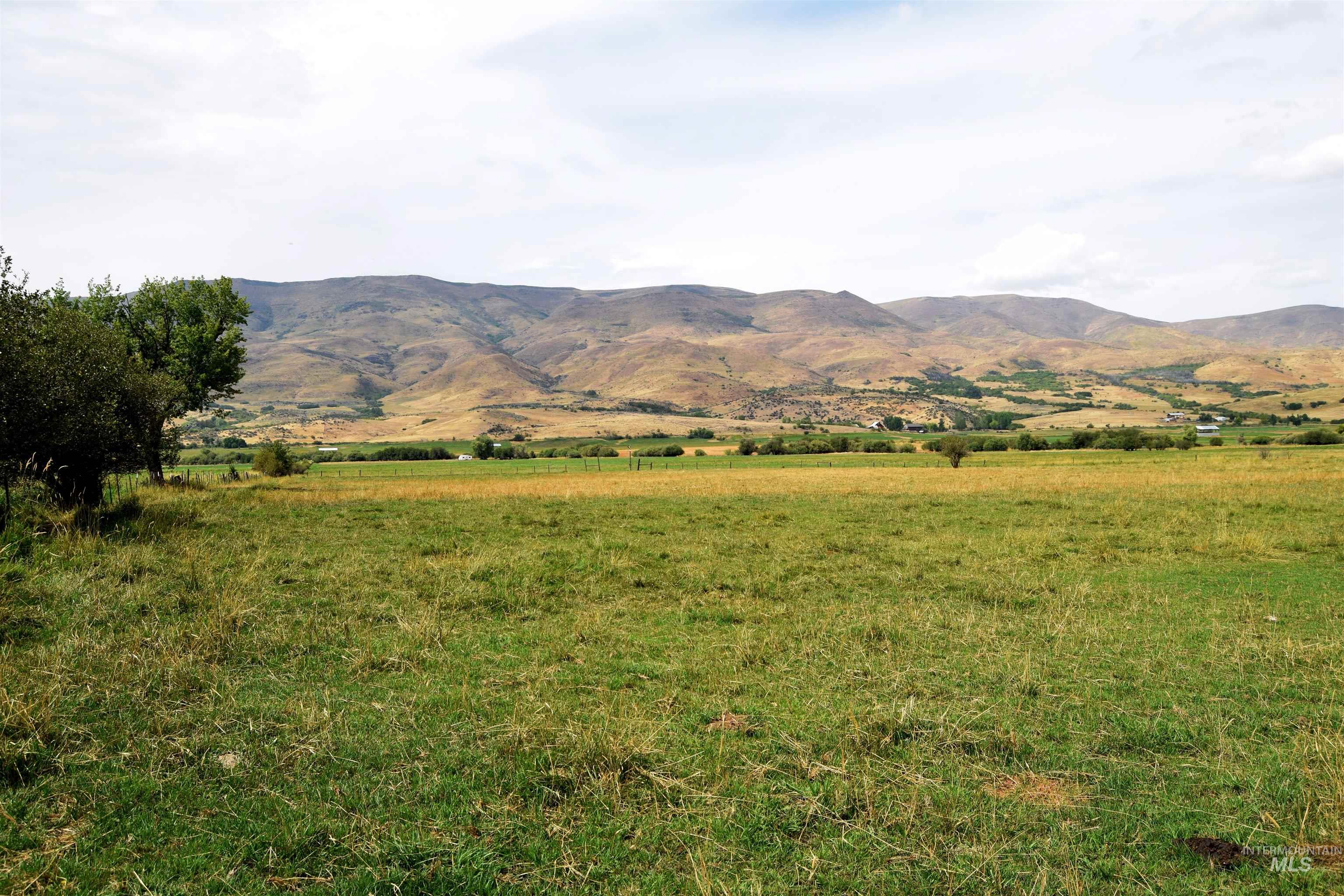 View of mountain backdrop featuring rural landscape