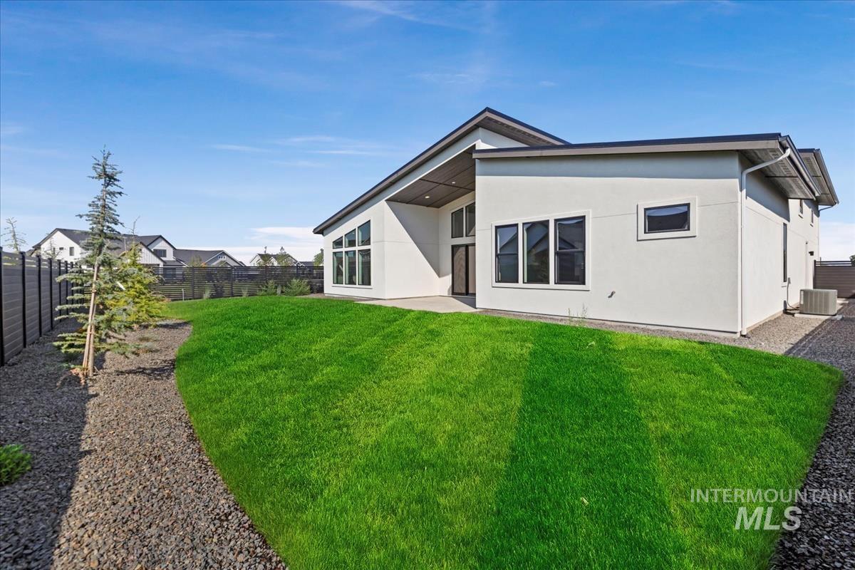 Back of property with a patio area, a fenced backyard, and stucco siding