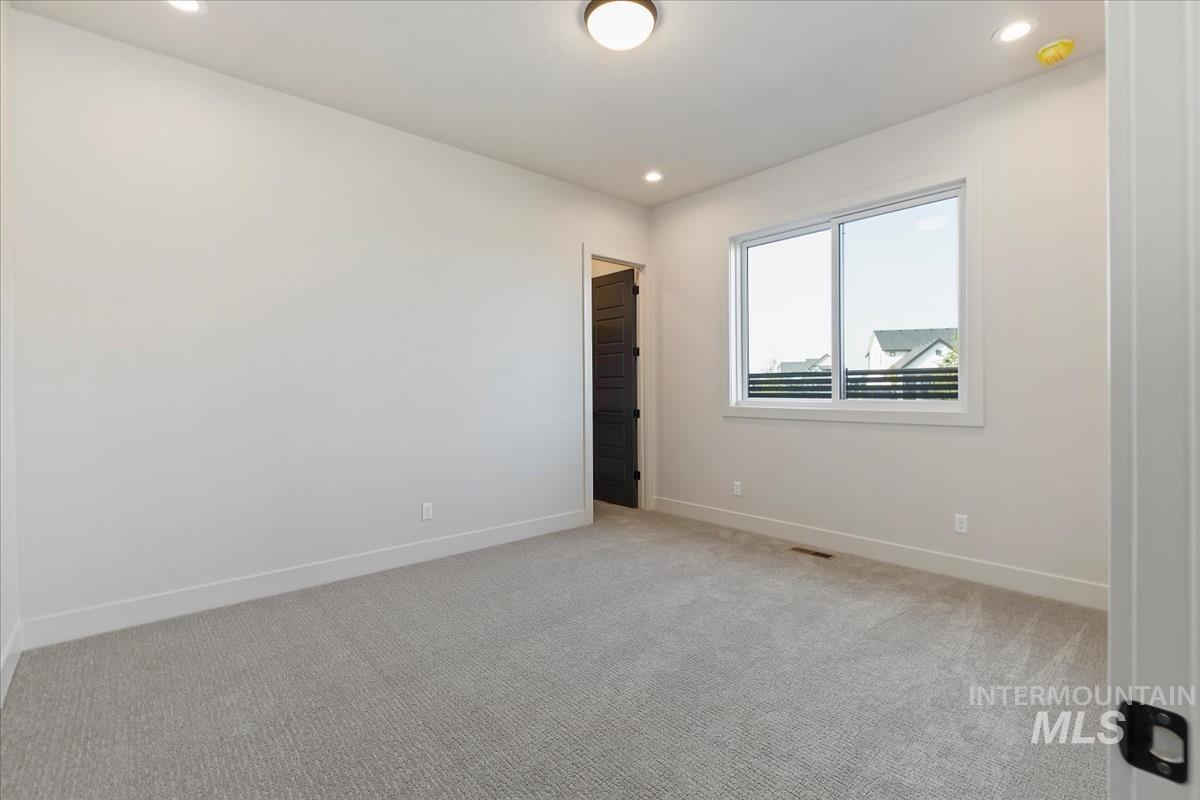 Spare room with light colored carpet and recessed lighting