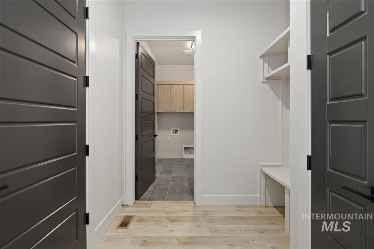 Spacious closet with light wood-type flooring