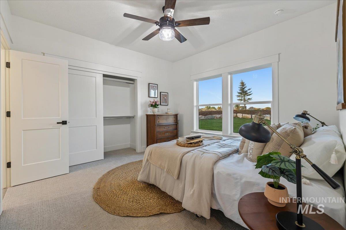 Bedroom with carpet floors, a closet, and ceiling fan