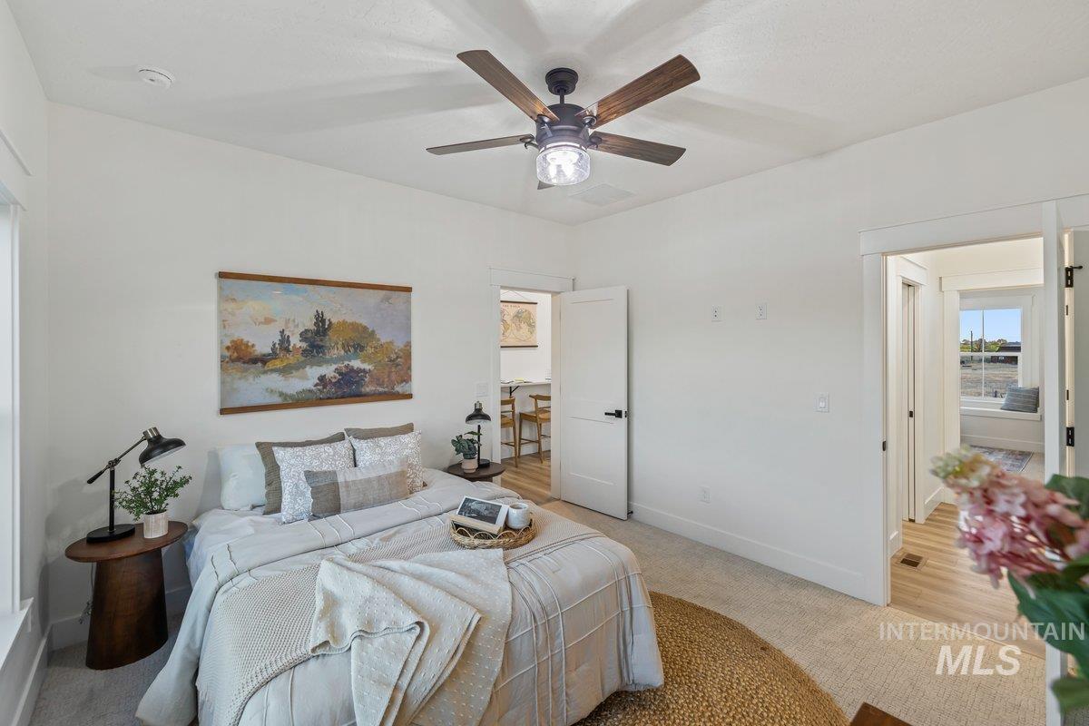 Bedroom featuring light colored carpet and a ceiling fan