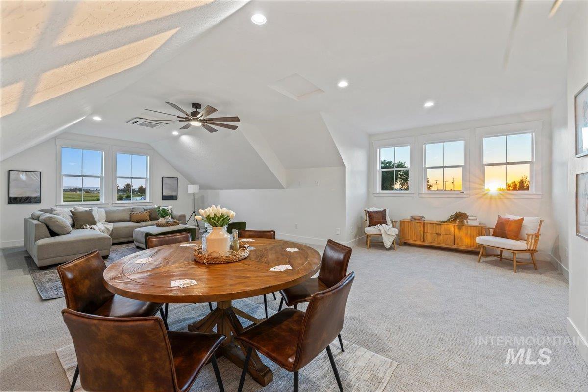 Dining area featuring light colored carpet, recessed lighting, and vaulted ceiling