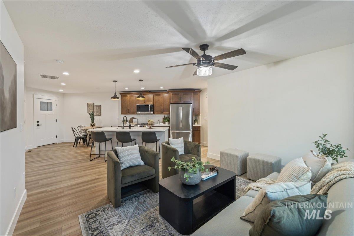Living area featuring recessed lighting, light wood-style floors, and ceiling fan