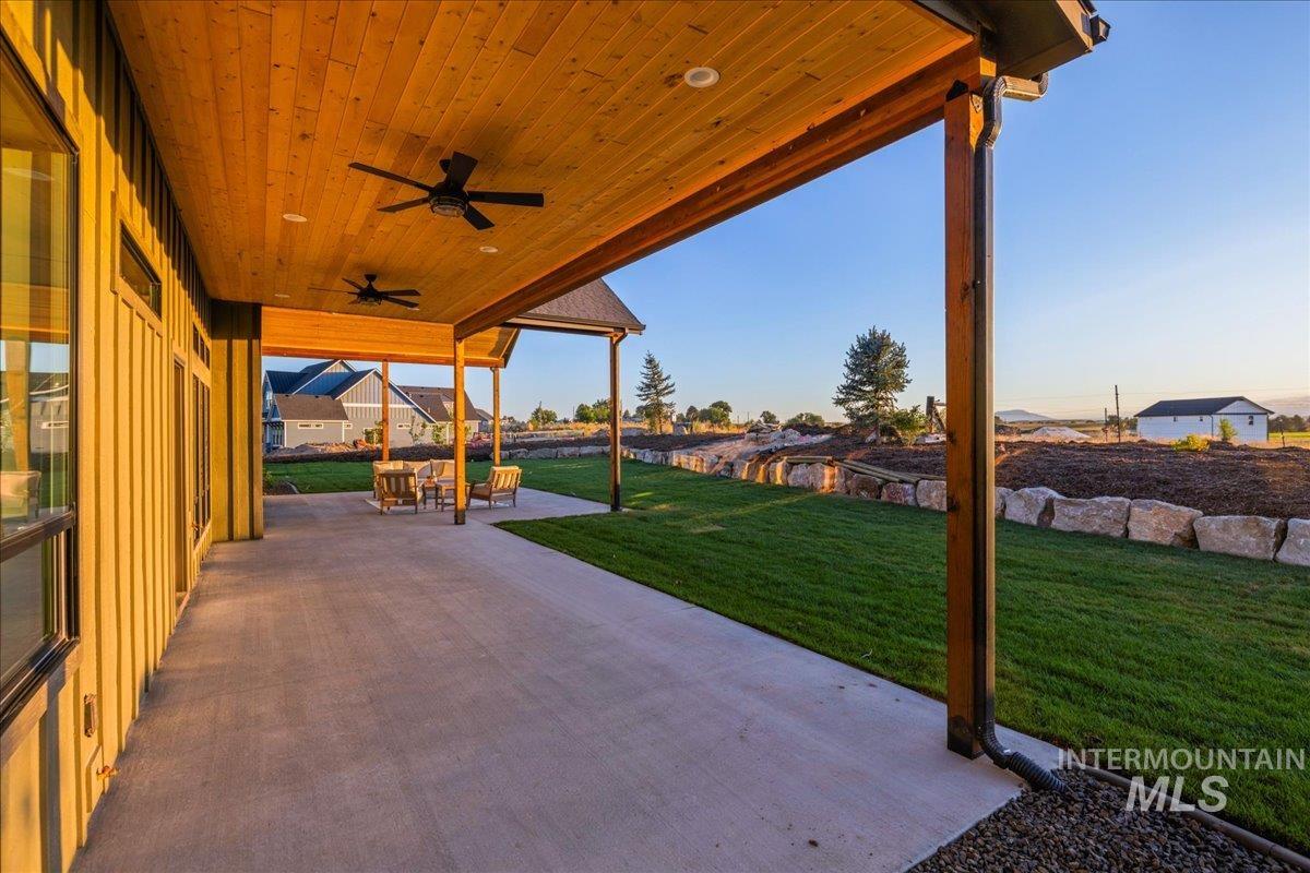View of patio with a ceiling fan and a residential view