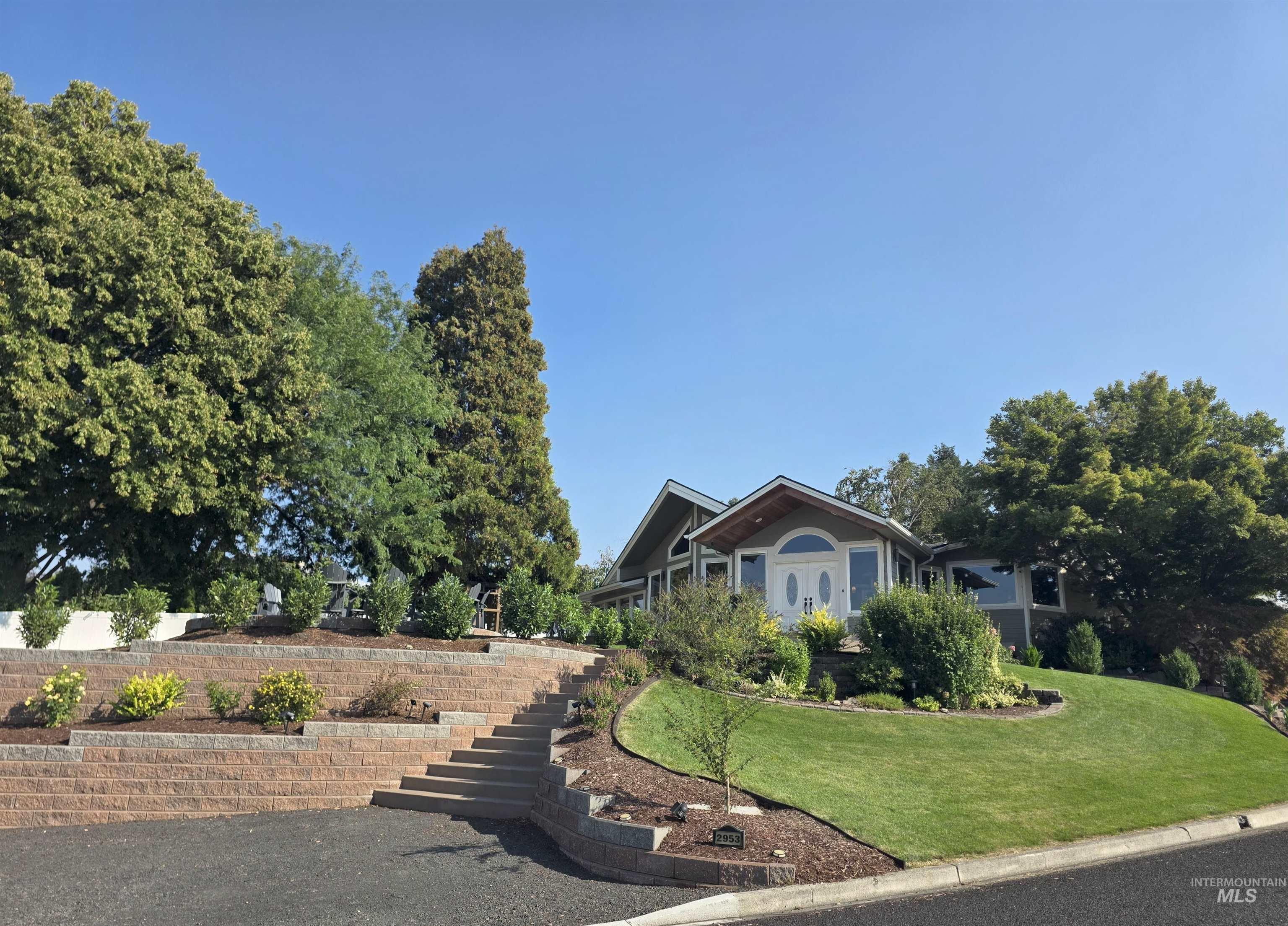 View of front of property with a front lawn and stairs