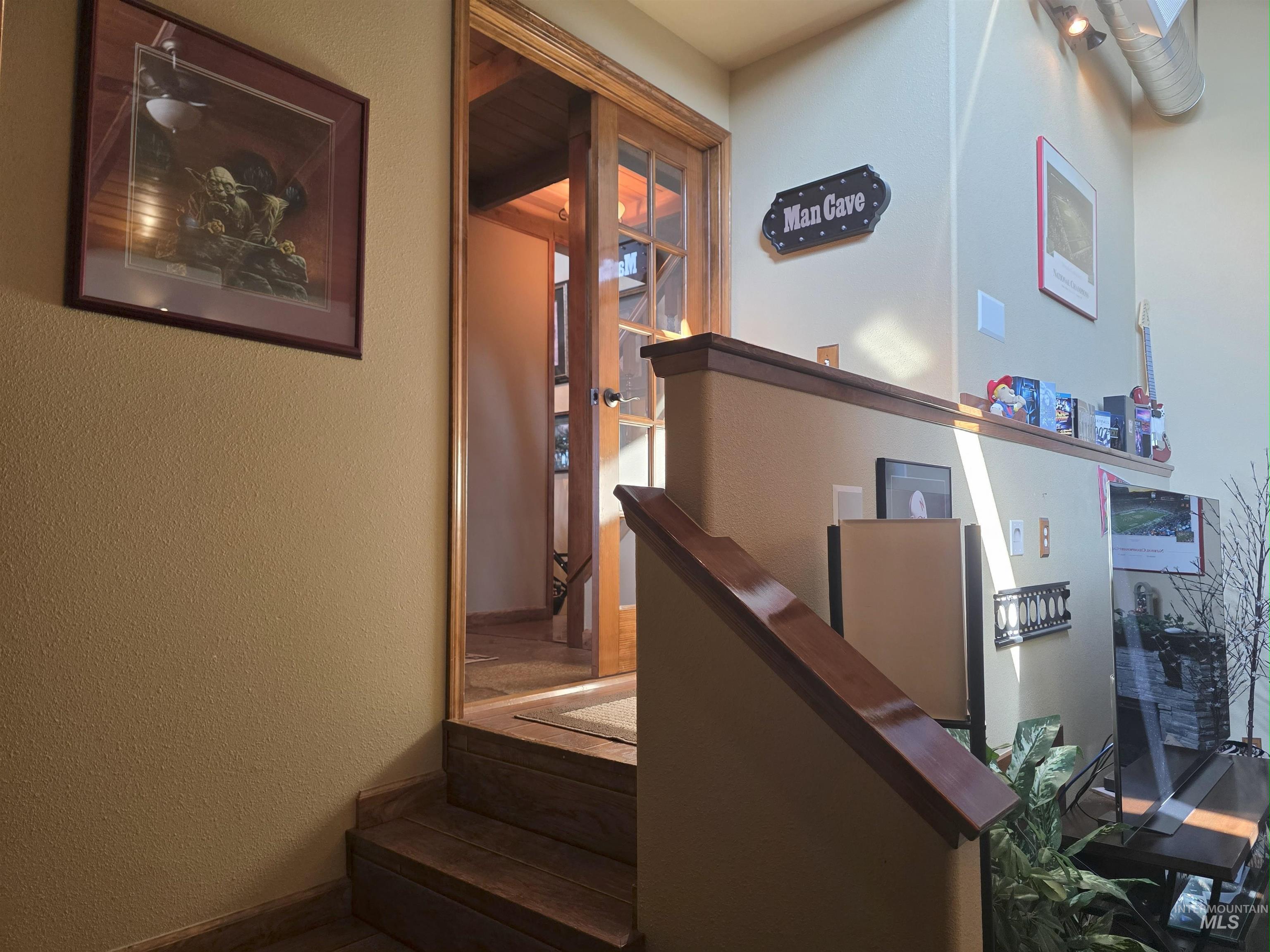 Staircase with a textured wall and baseboards