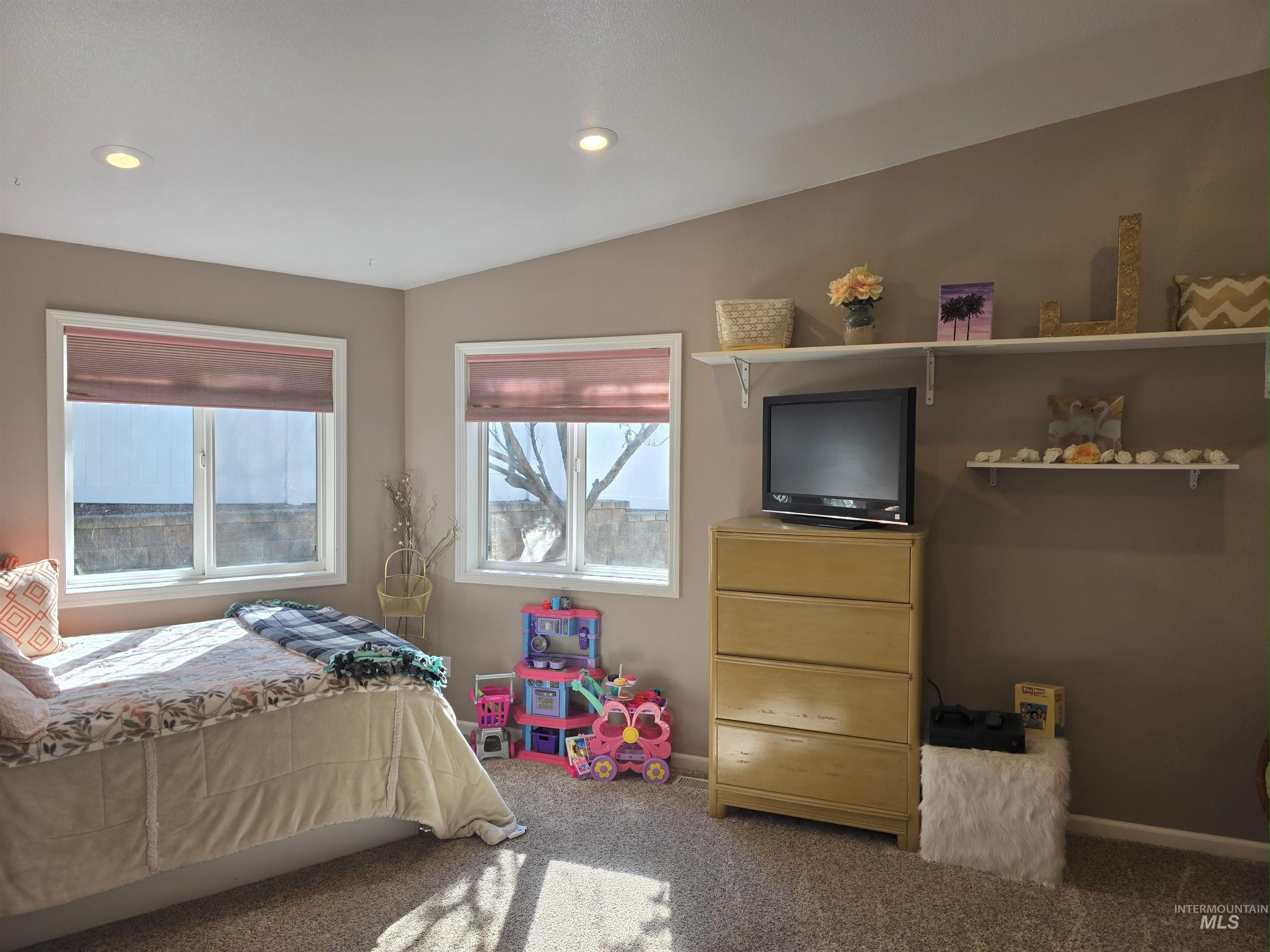 Bedroom with multiple windows, carpet flooring, and recessed lighting