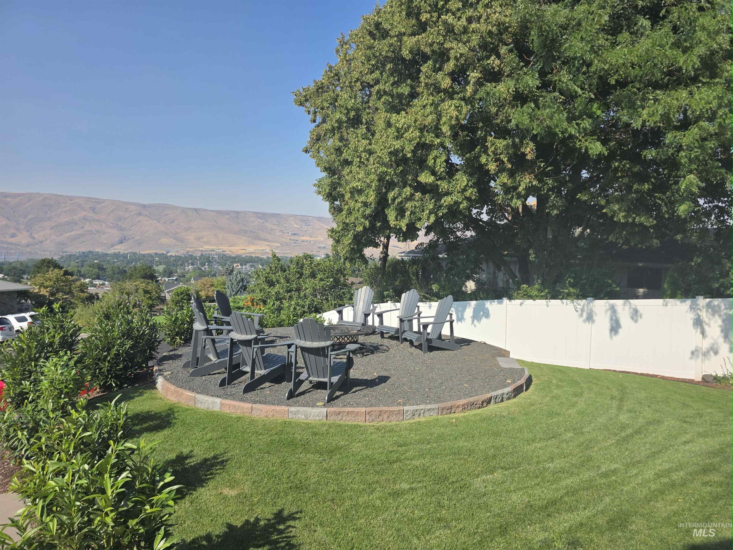 View of yard with a patio, a mountain view, and a fire pit