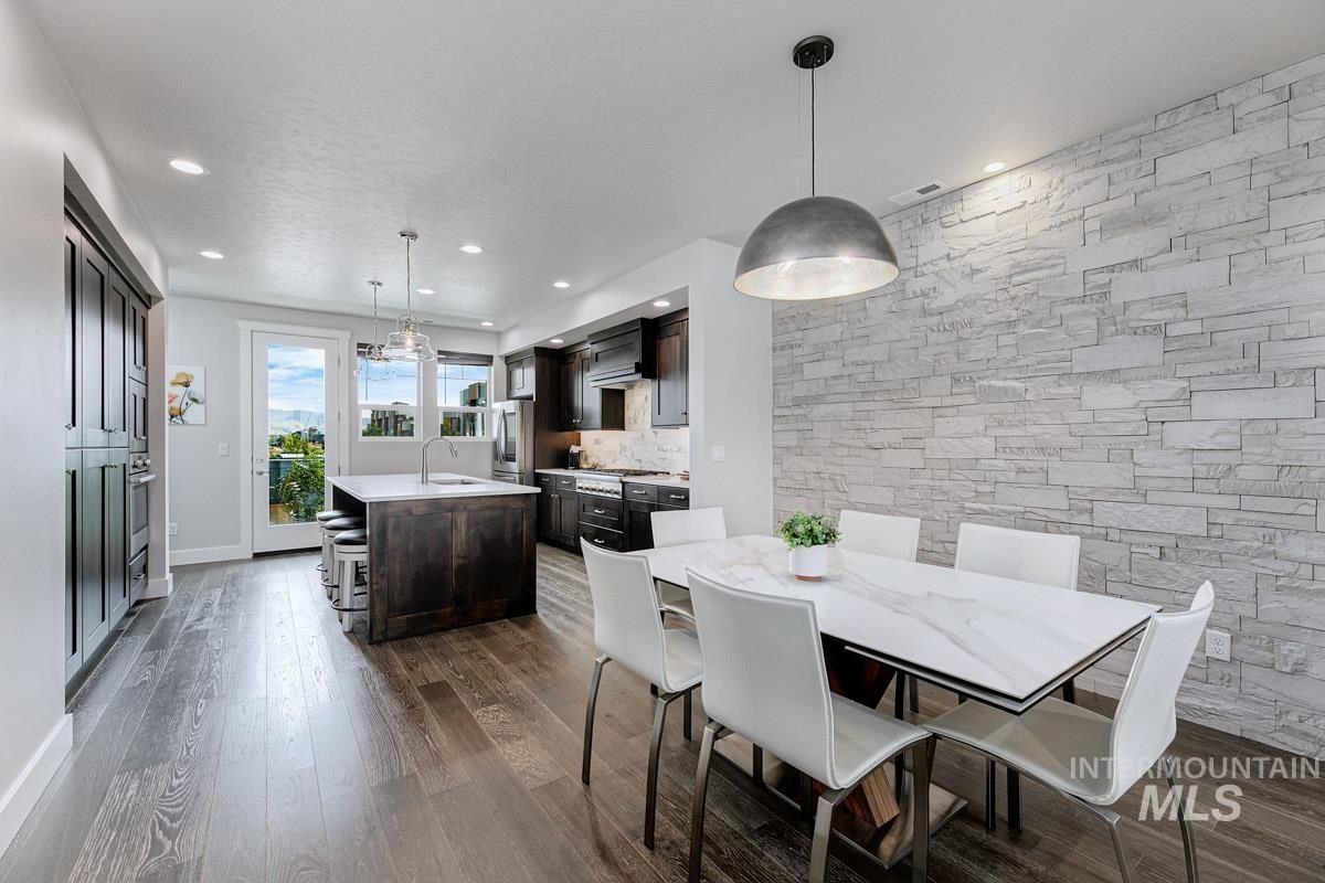 Dining area featuring dark wood finished floors and recessed lighting
