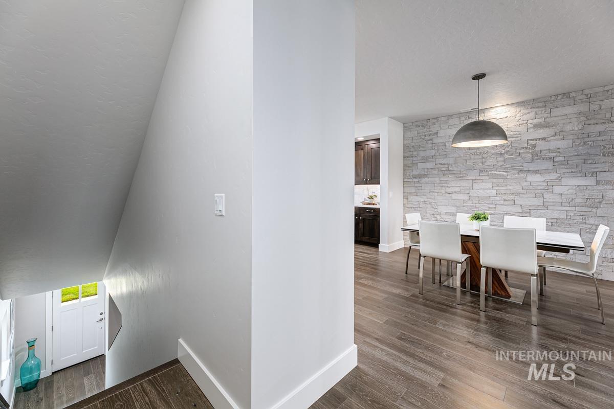 Staircase featuring wood finished floors and a textured ceiling