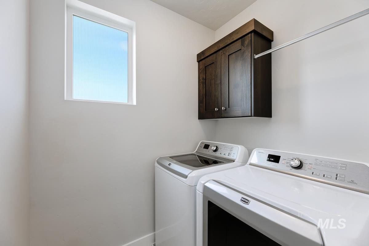 Laundry area with cabinet space and washing machine and dryer