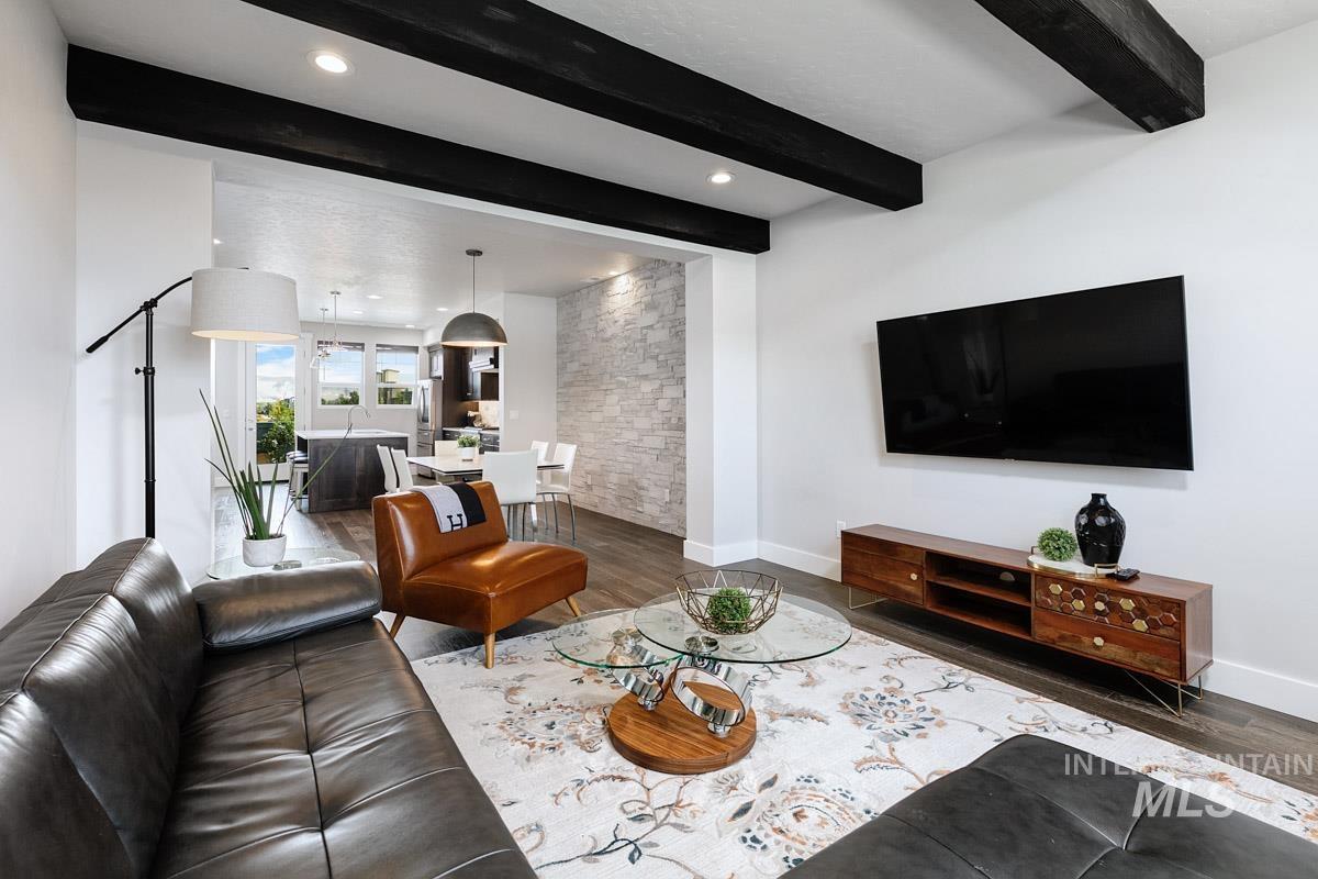Living area featuring beamed ceiling, wood finished floors, and recessed lighting