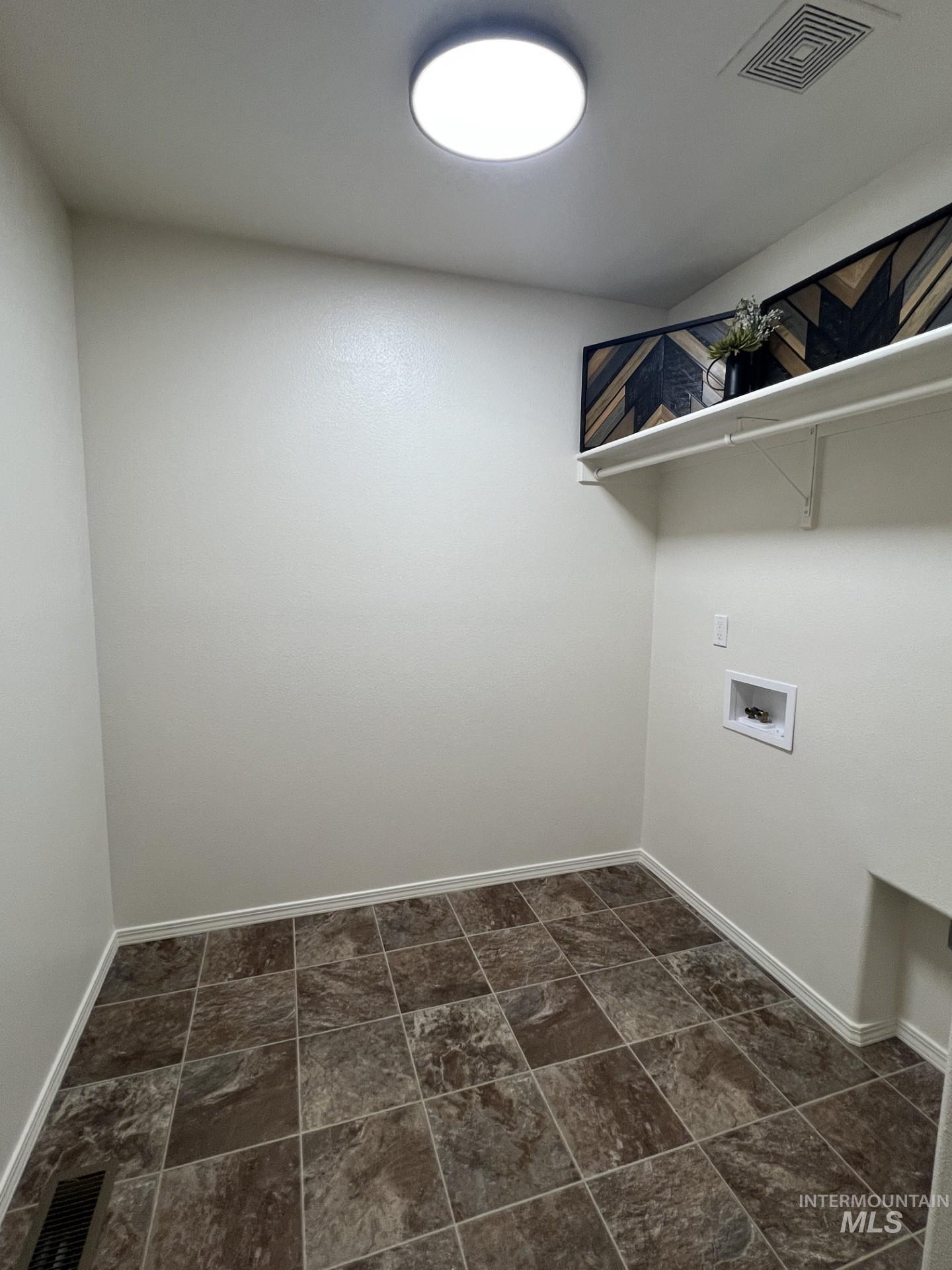 Laundry room featuring baseboards and hookup for a washing machine
