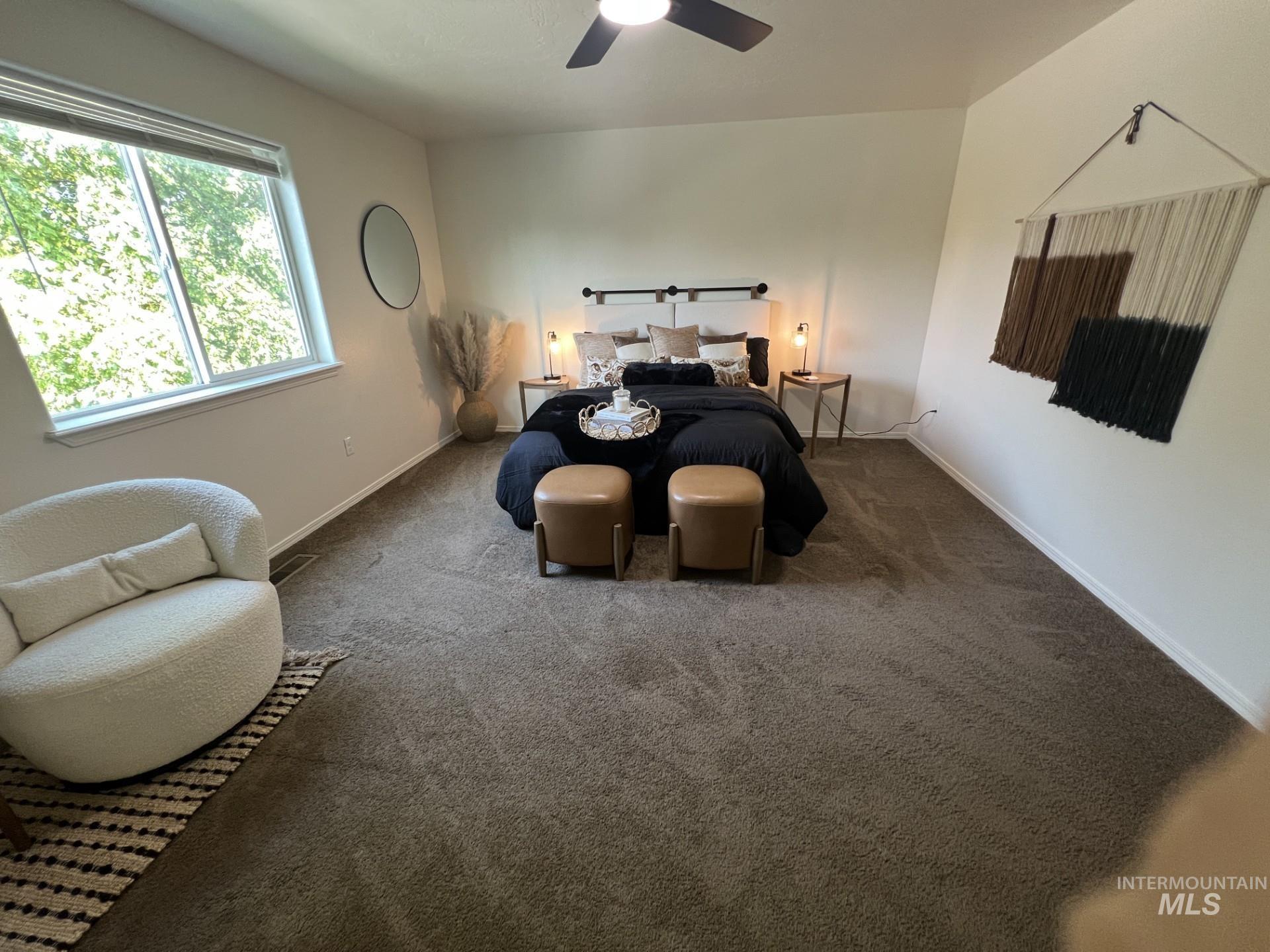 Bedroom with carpet floors and a ceiling fan