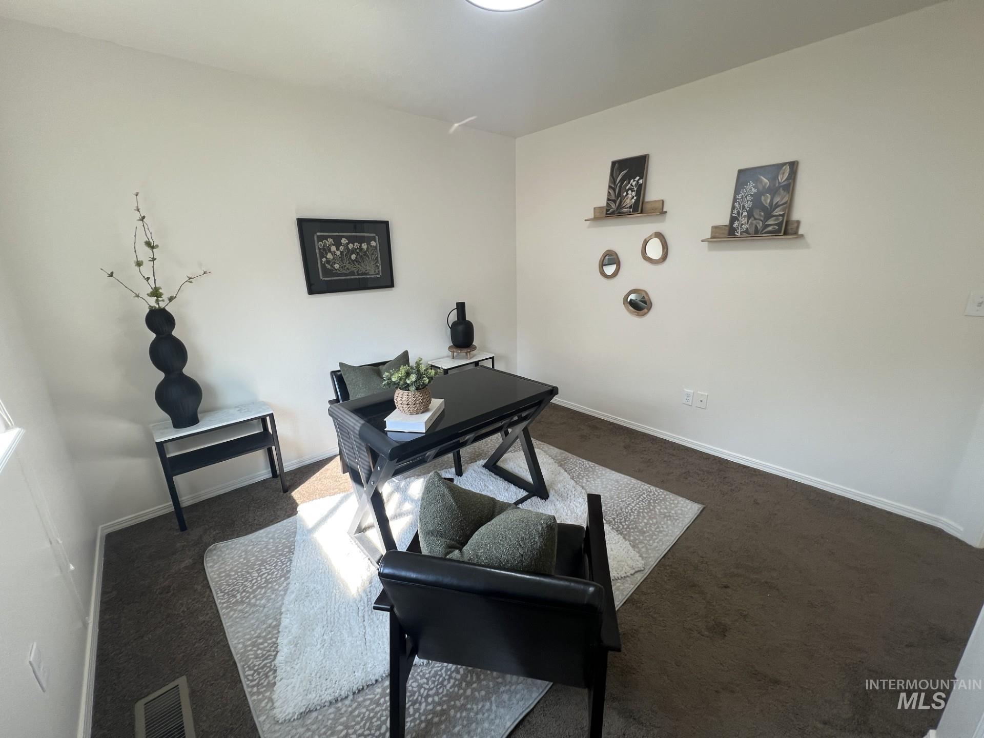 Carpeted office space featuring baseboards