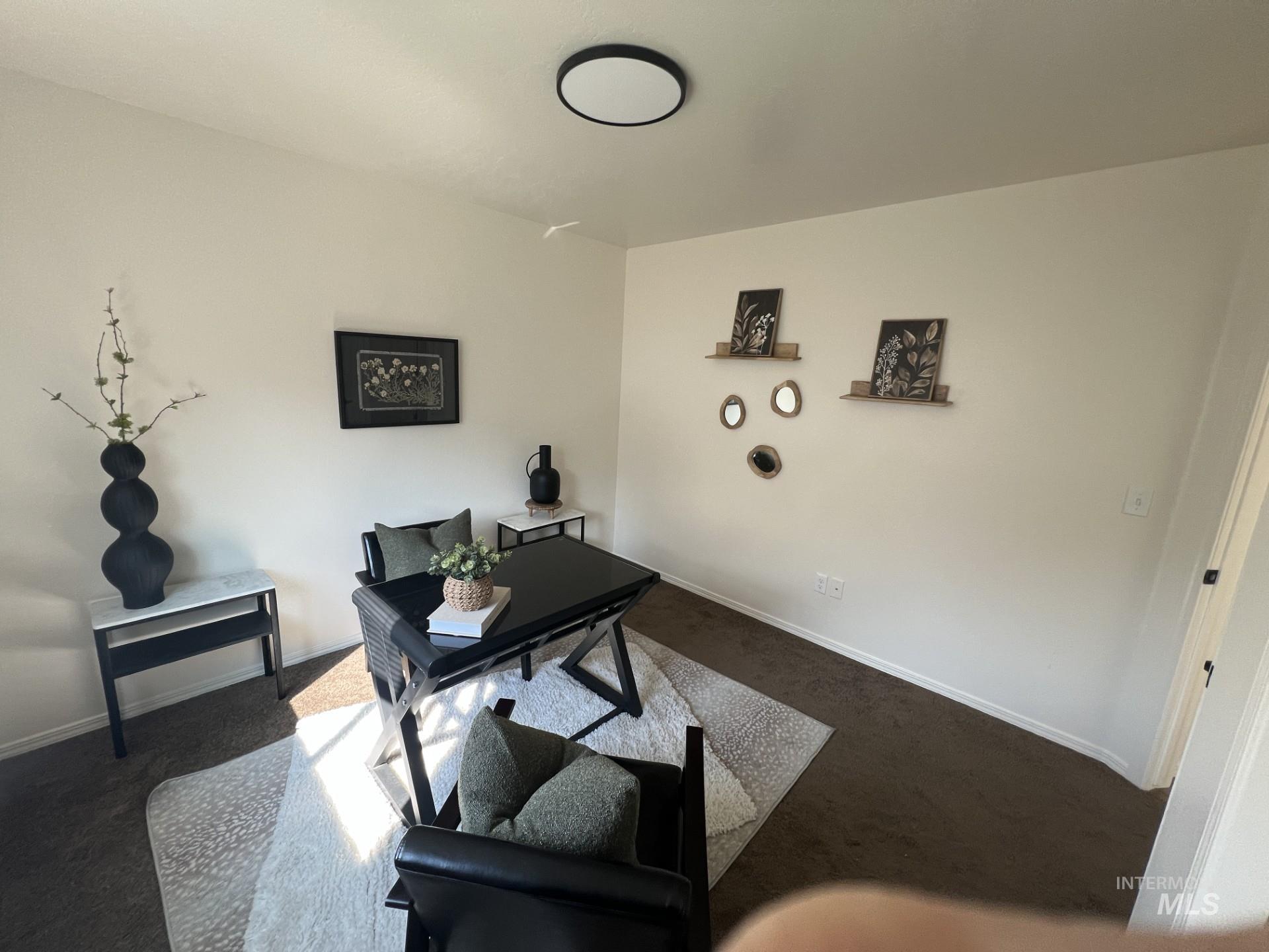 Office space featuring carpet floors and baseboards