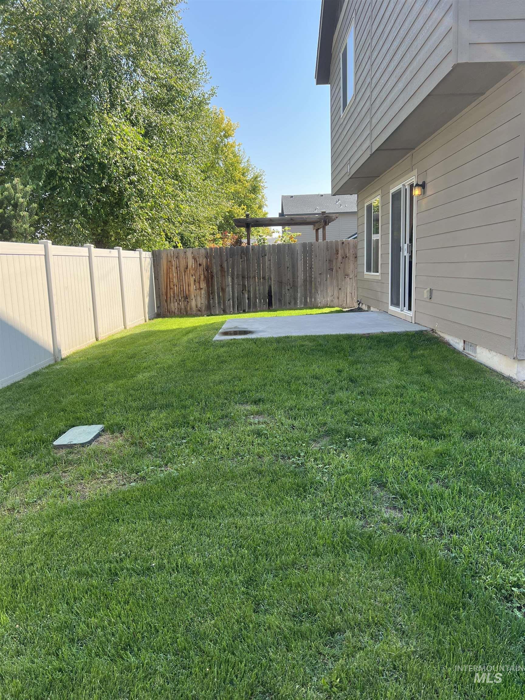 Fenced backyard with a patio