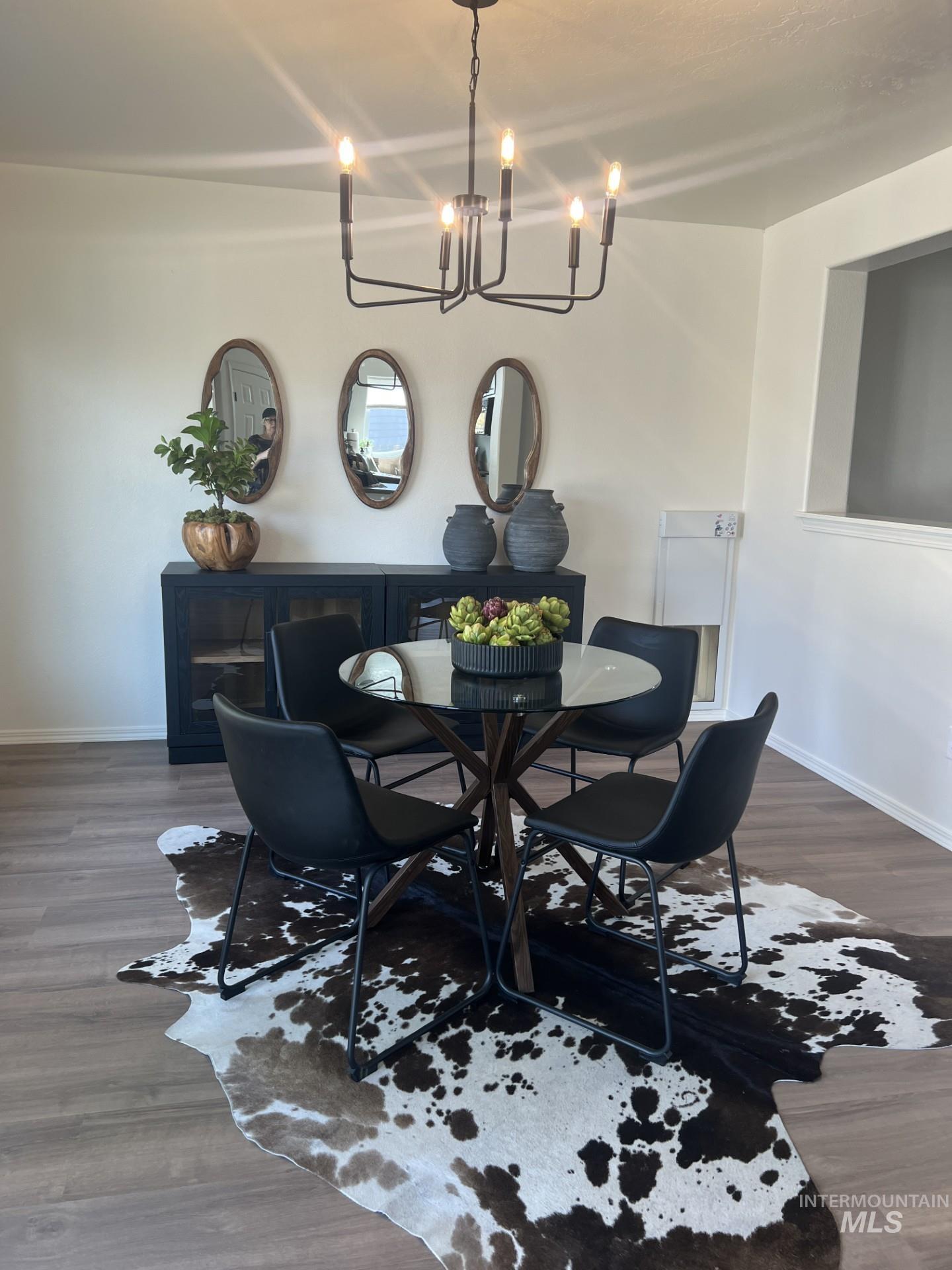Dining area with dark wood finished floors and a chandelier
