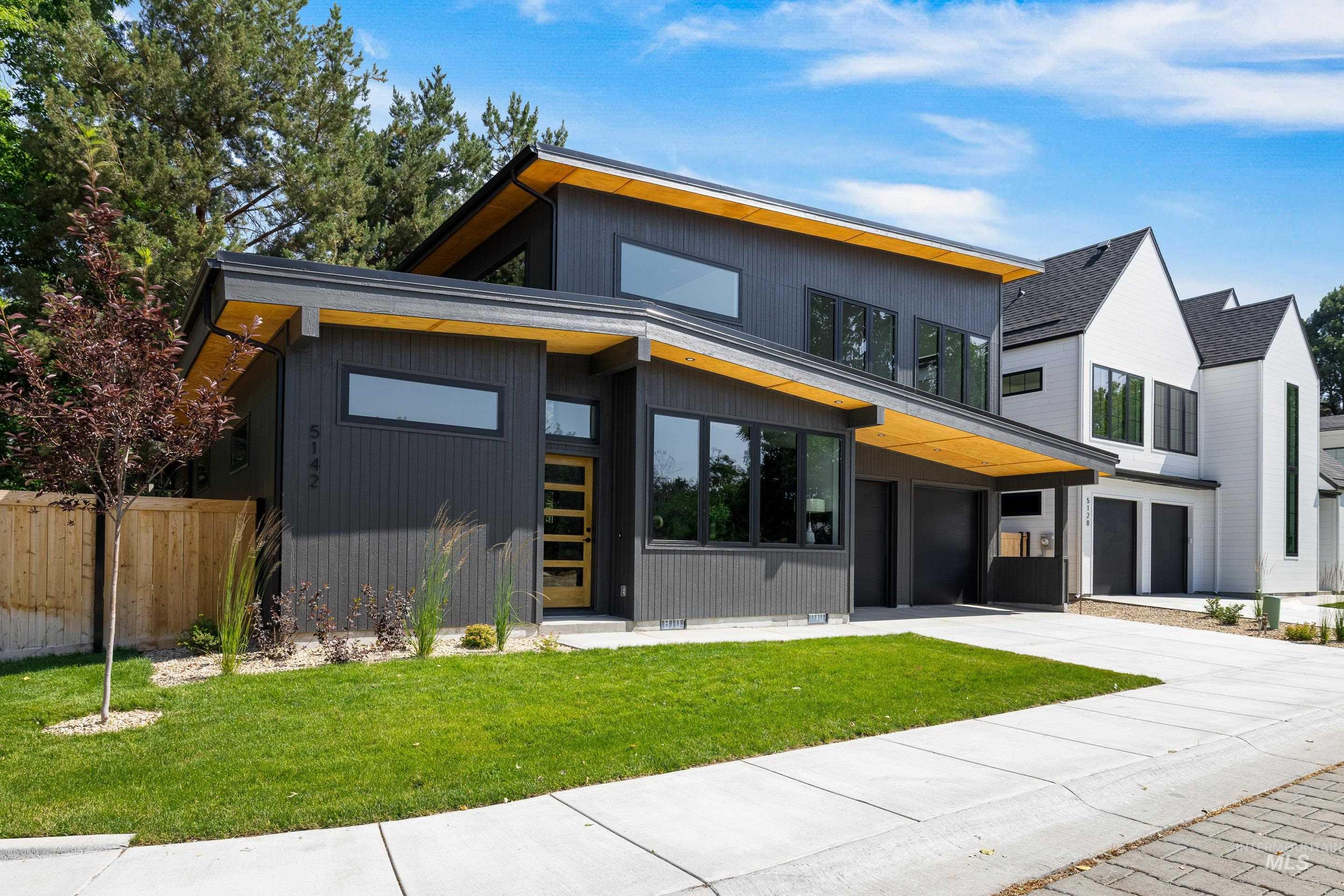 Contemporary house with concrete driveway and a garage