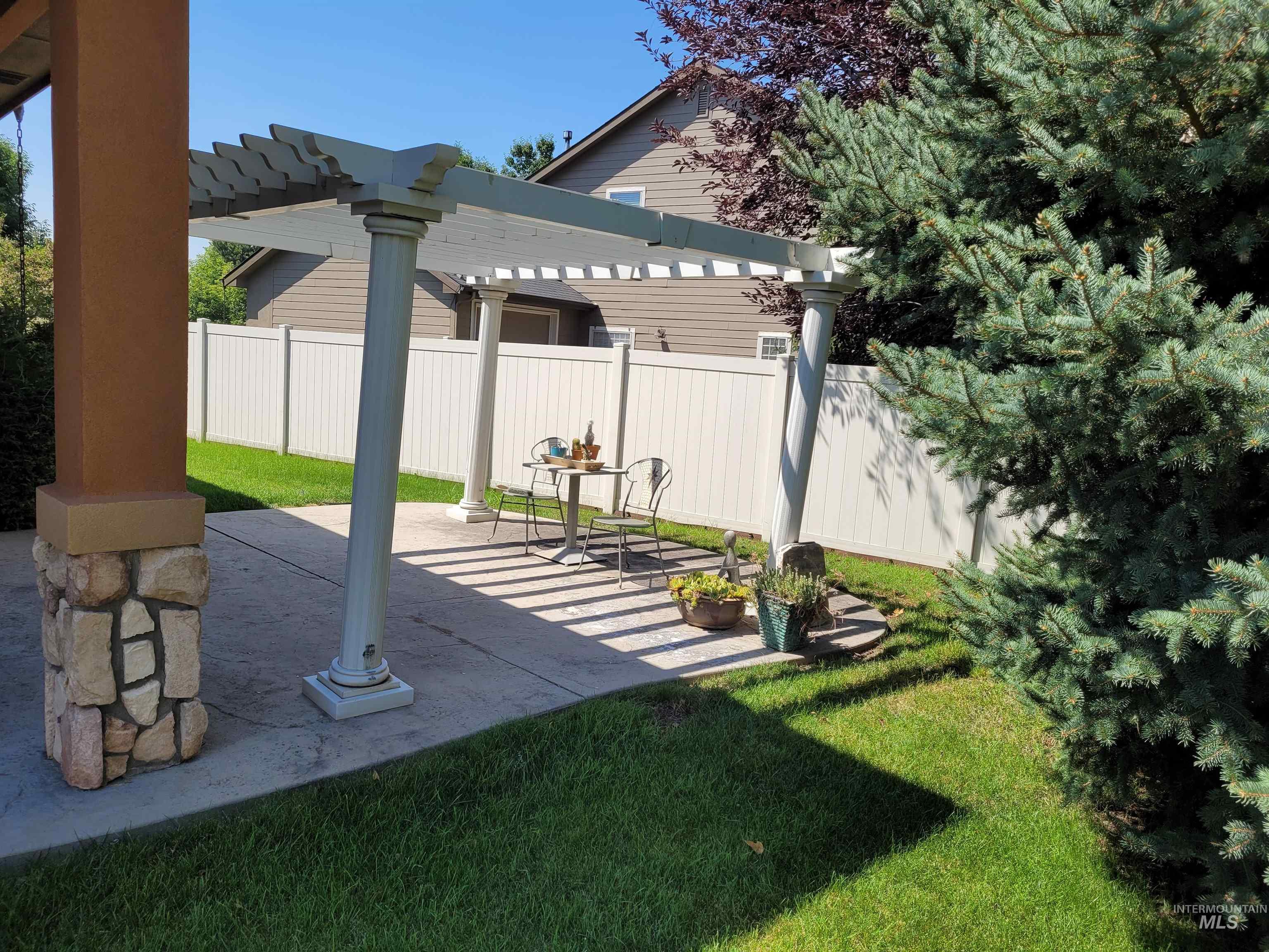 View of yard with a pergola and a patio