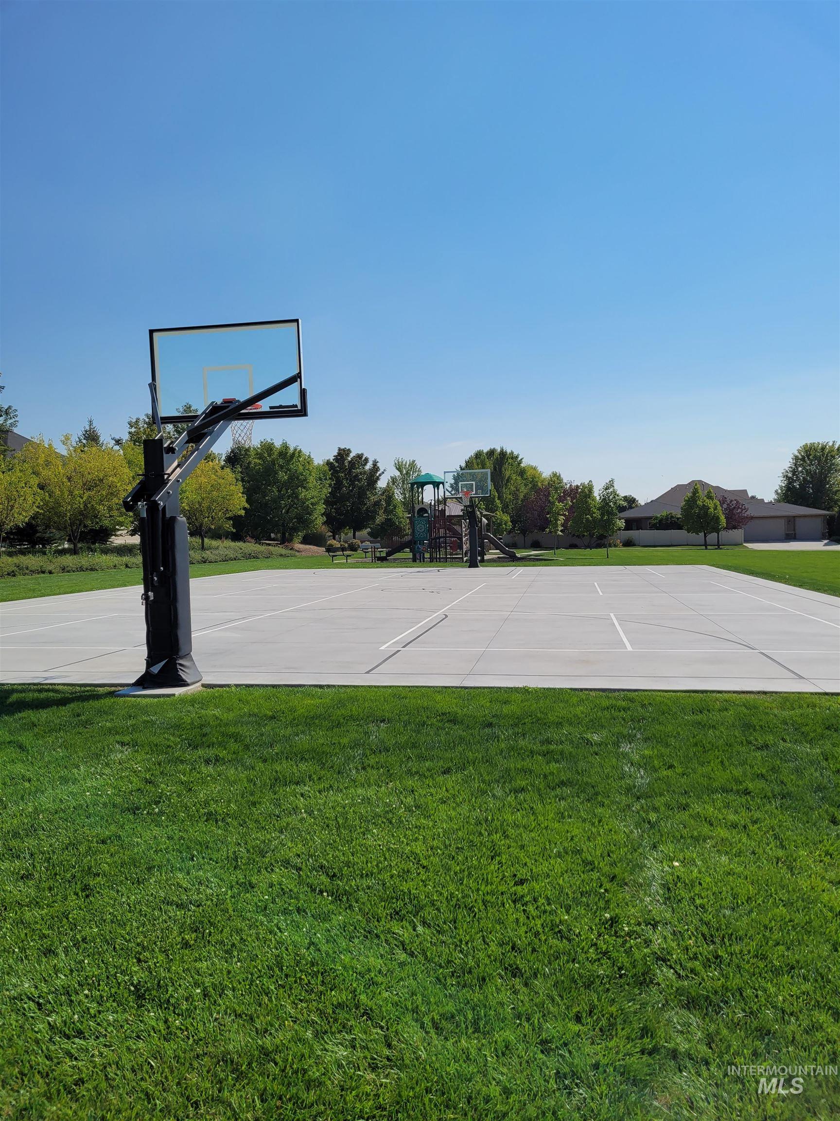 View of sport court with community basketball court and a yard
