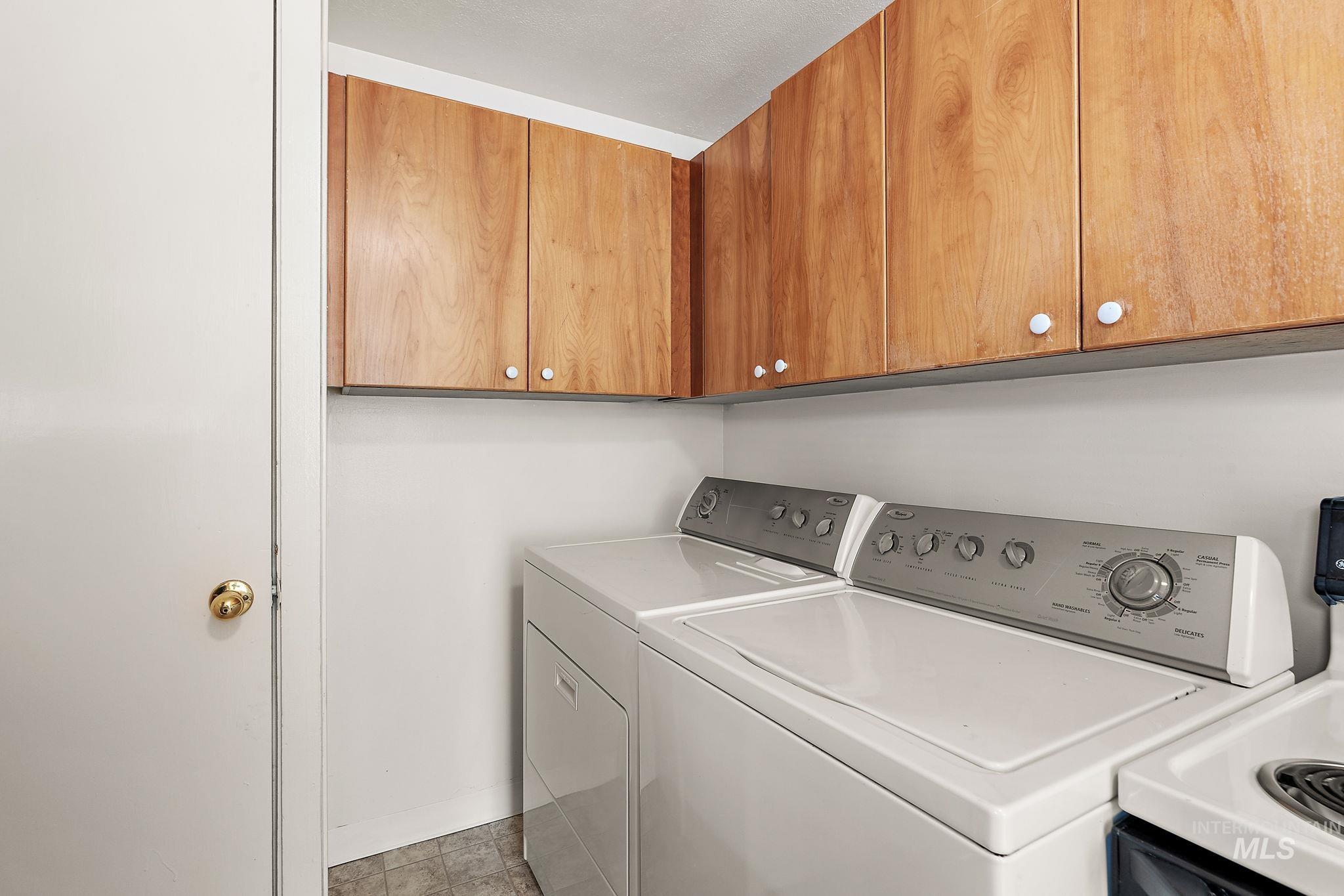 Laundry area featuring washer and dryer and cabinet space