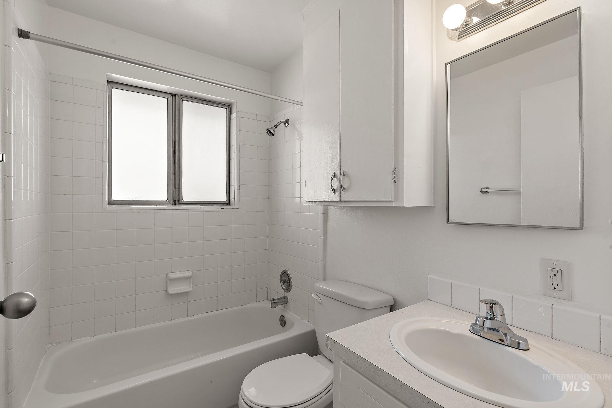 Bathroom featuring shower / washtub combination and vanity
