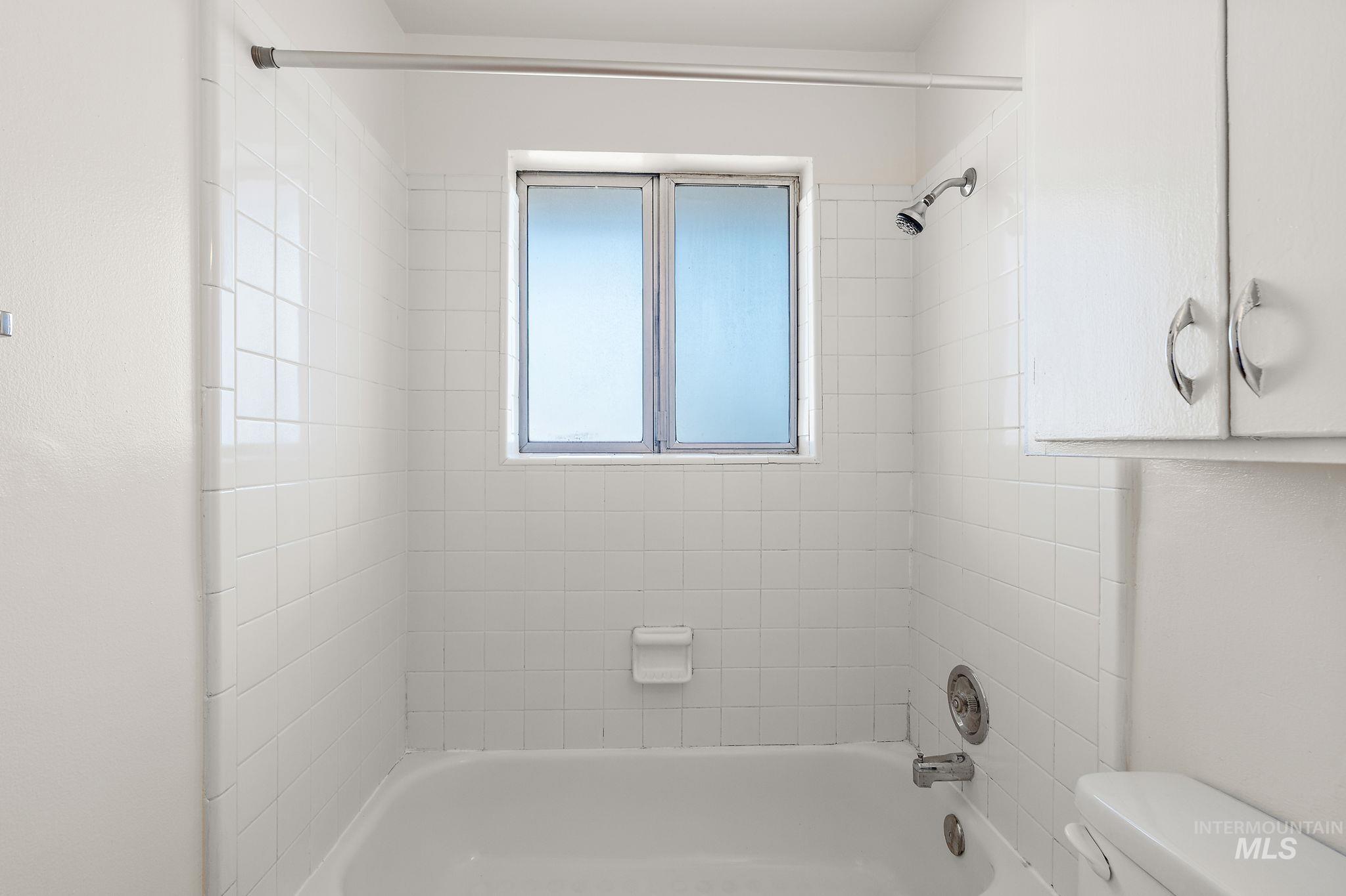 Full bath featuring shower / bathtub combination and toilet