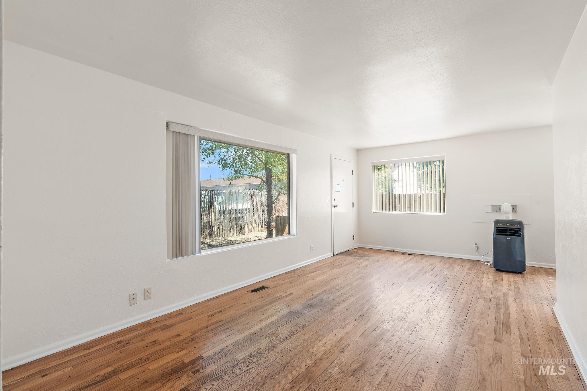 Unfurnished living room with wood-type flooring