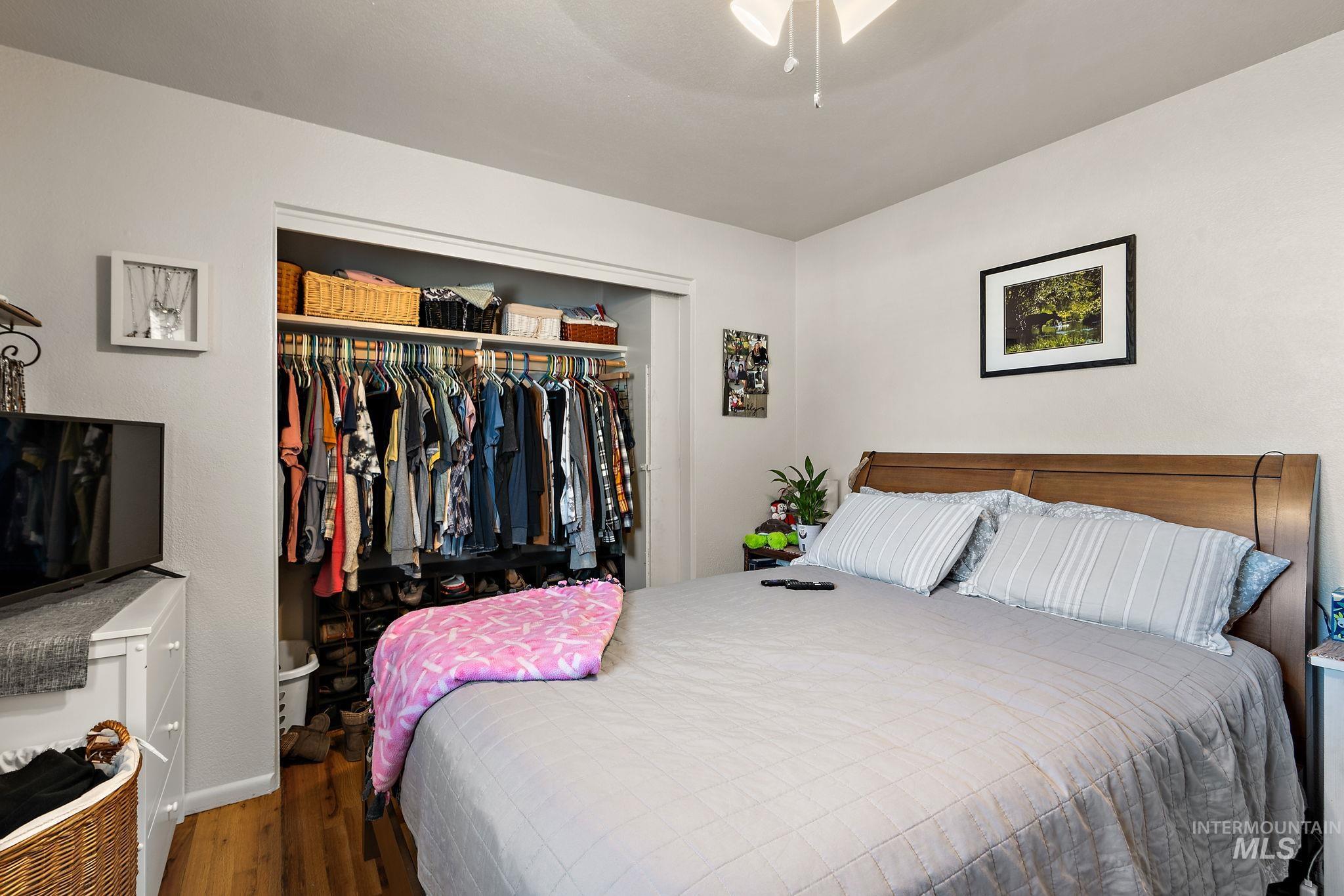Bedroom with a closet and wood finished floors