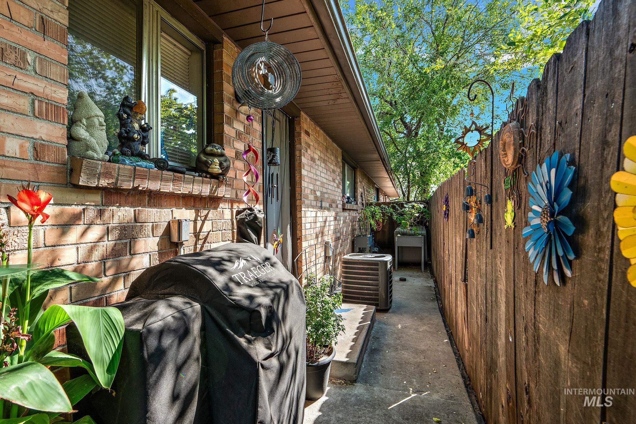 View of side of property with brick siding and a cooling unit