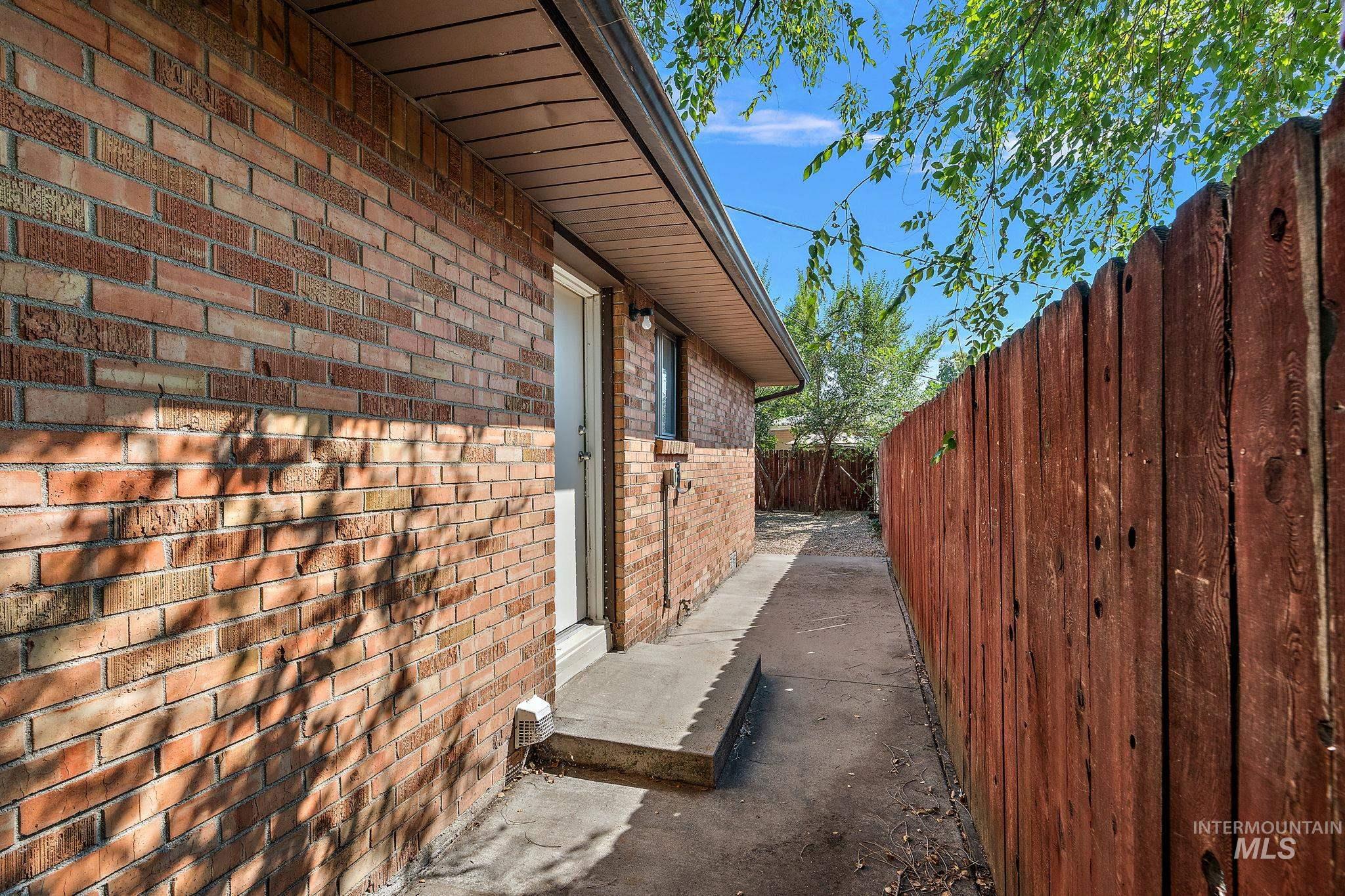 View of side of property featuring brick siding