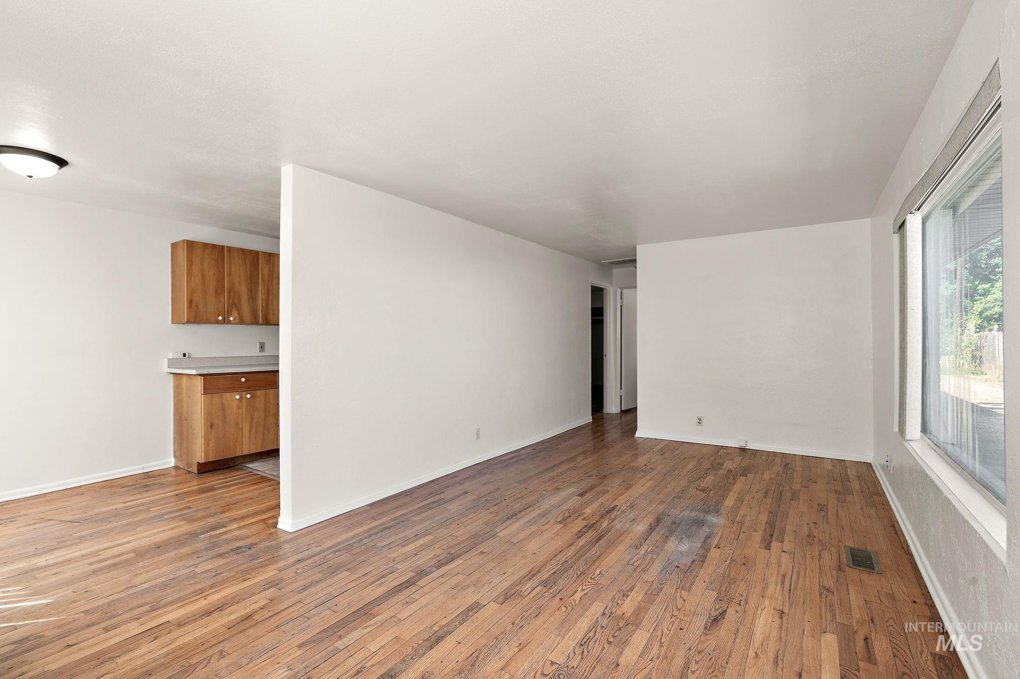 Spare room featuring light wood-style floors and baseboards