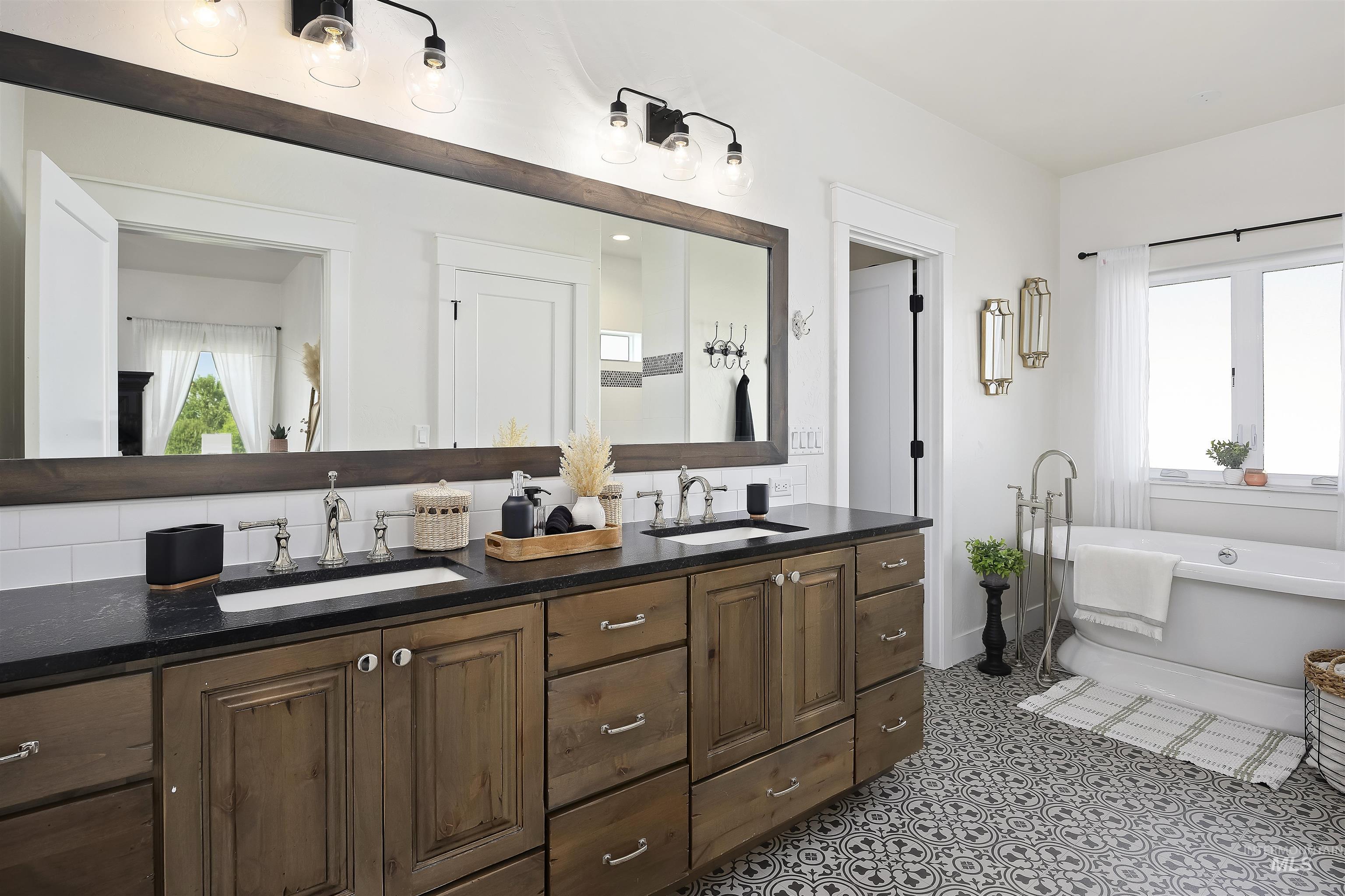 Full bath with double vanity and a freestanding bath