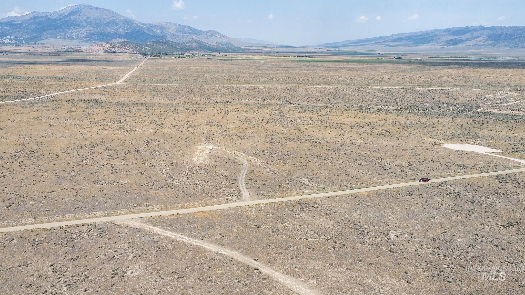 Aerial view of sparsely populated area with a mountain backdrop