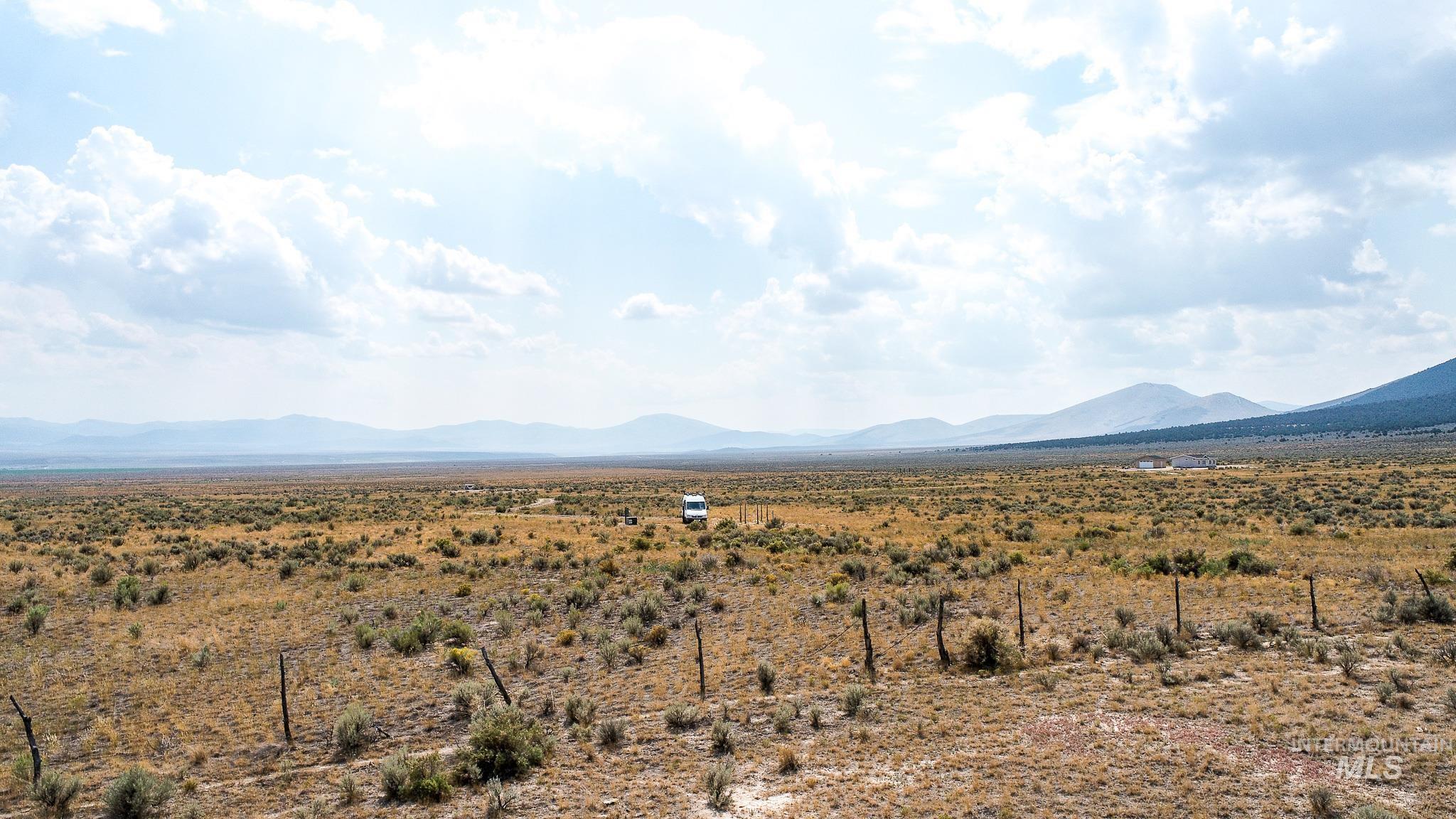 View of mountain background featuring rural landscape
