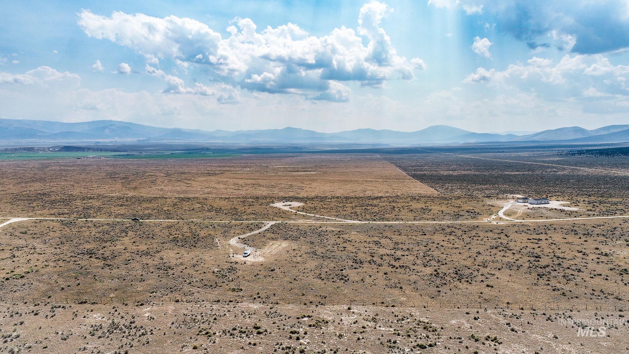 View of rural area with a mountain backdrop and a desert landscape