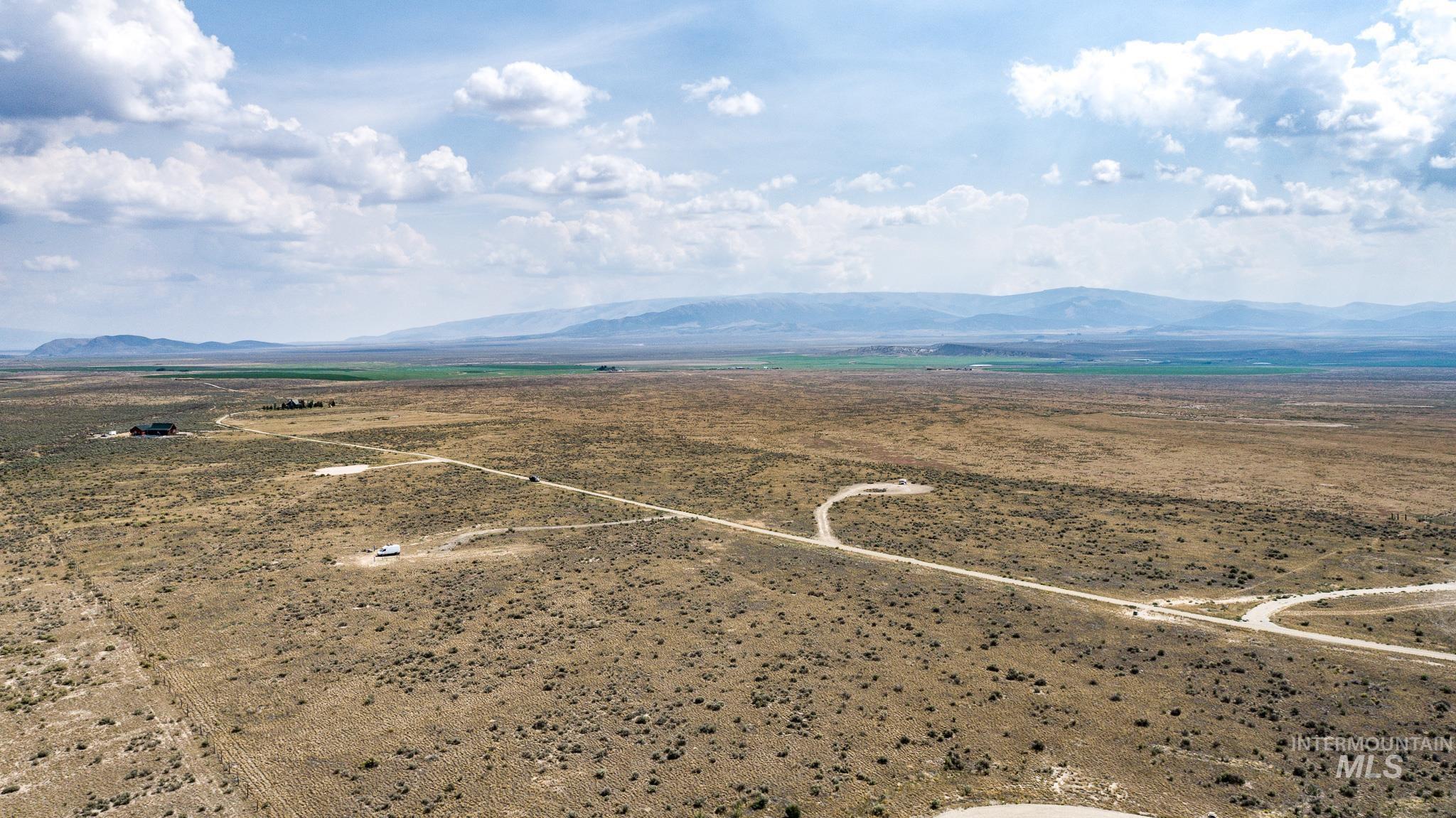 Overview of rural landscape featuring a mountainous background and a desert landscape