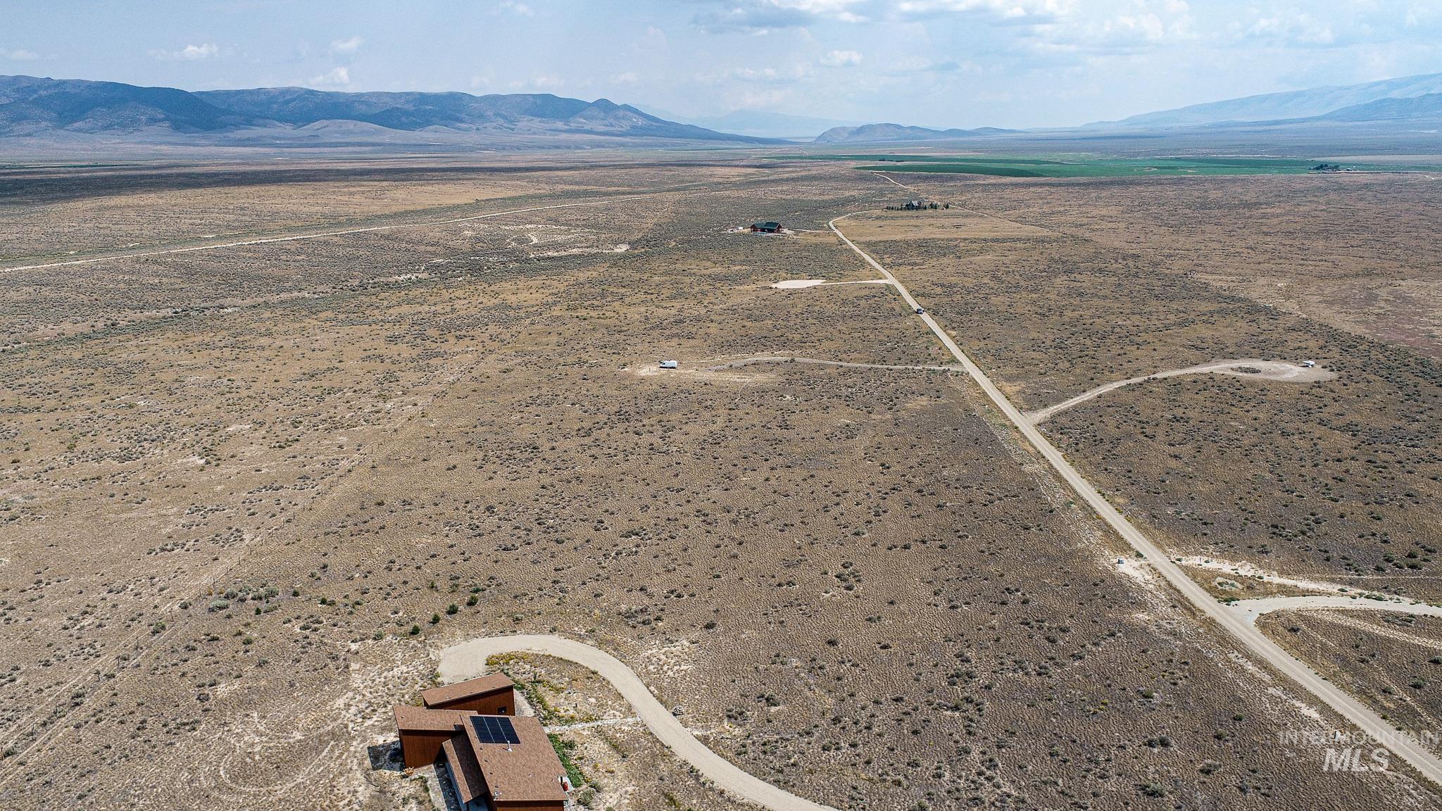 Overview of rural landscape with a mountain backdrop and a desert landscape