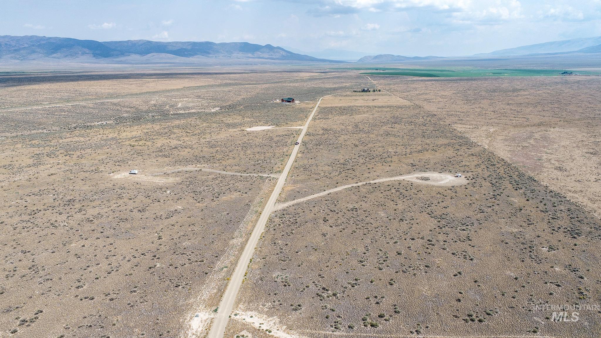 View of rural area featuring a mountain backdrop and a desert landscape