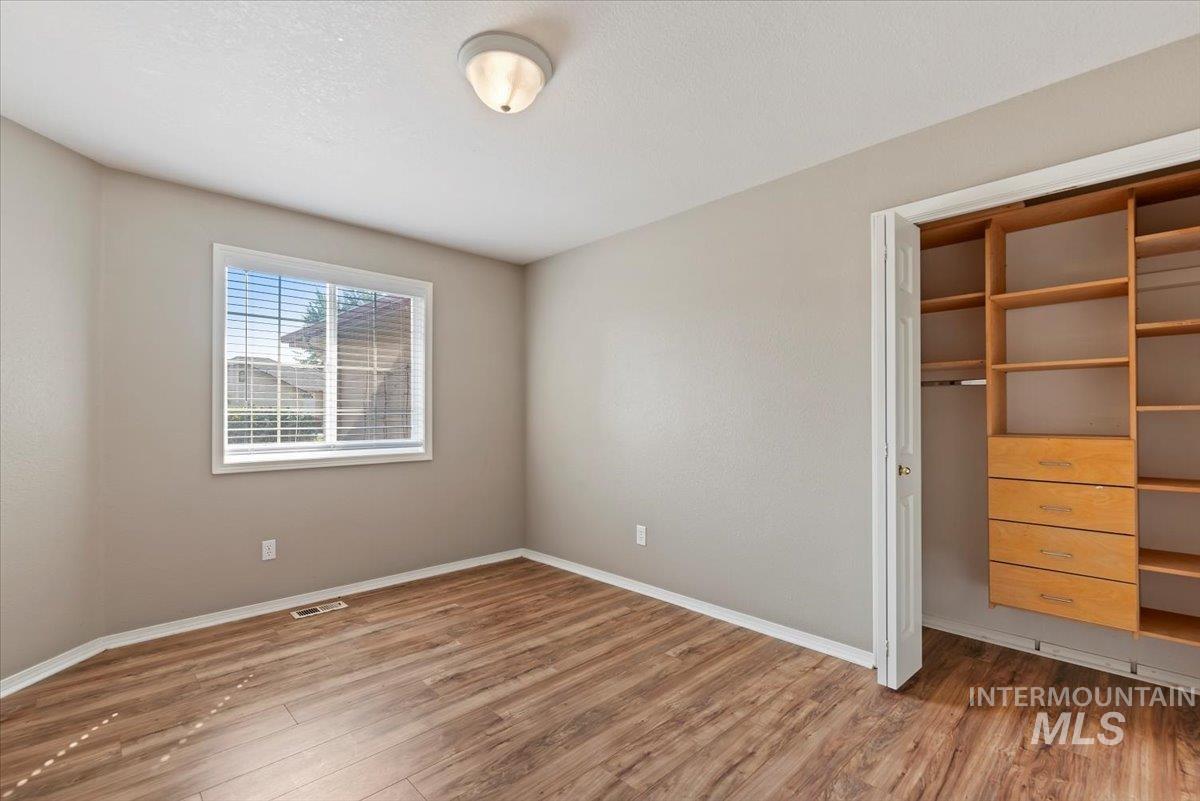 Unfurnished bedroom with light wood-type flooring and a closet
