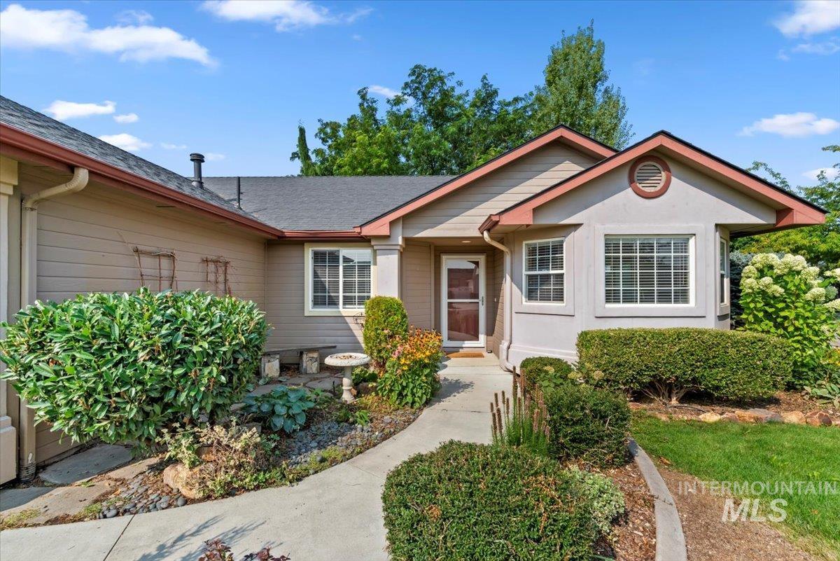 View of front of home with roof with shingles